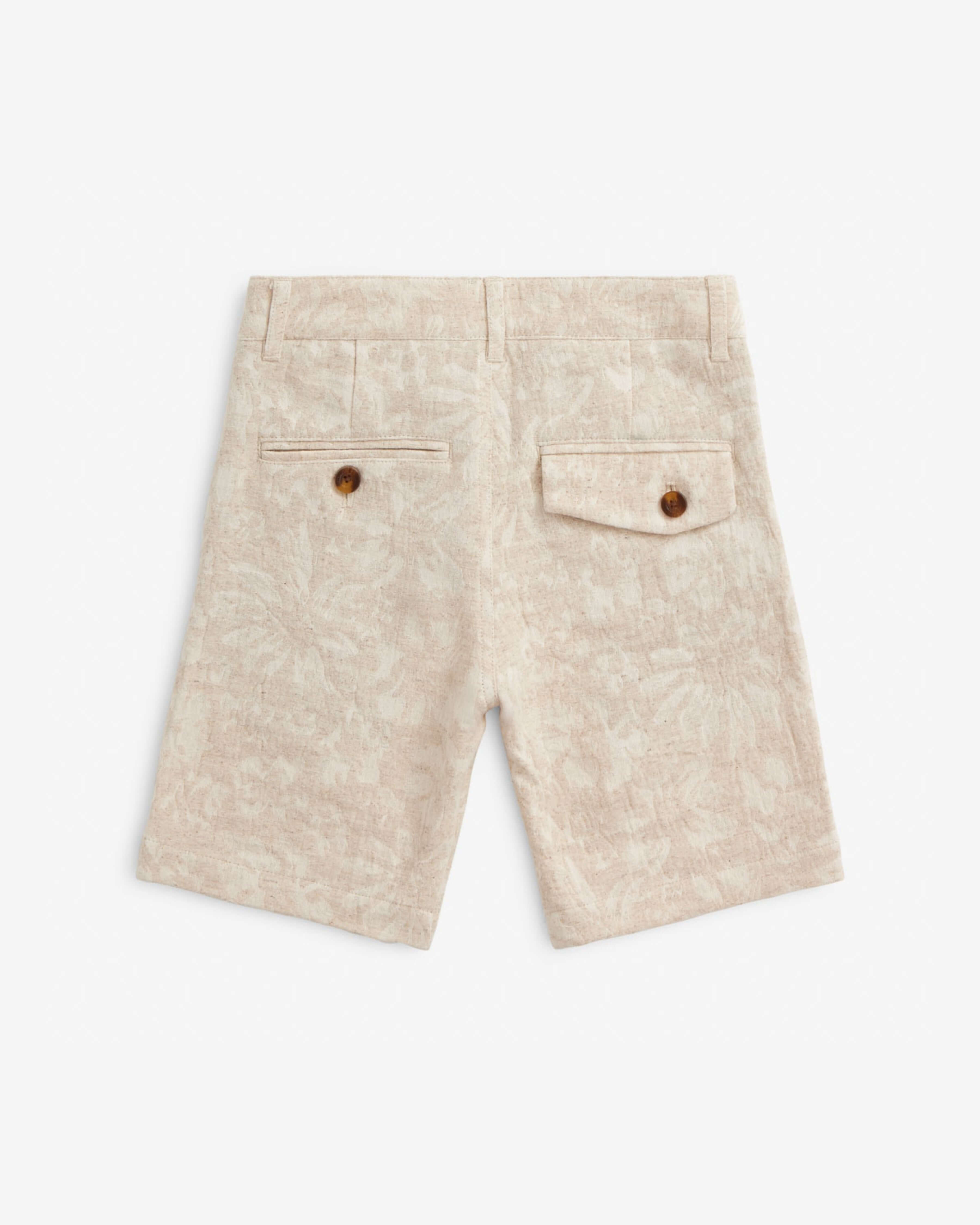 Back view of Linen Ivory Garden Trouser Short featuring button pockets and floral texture.