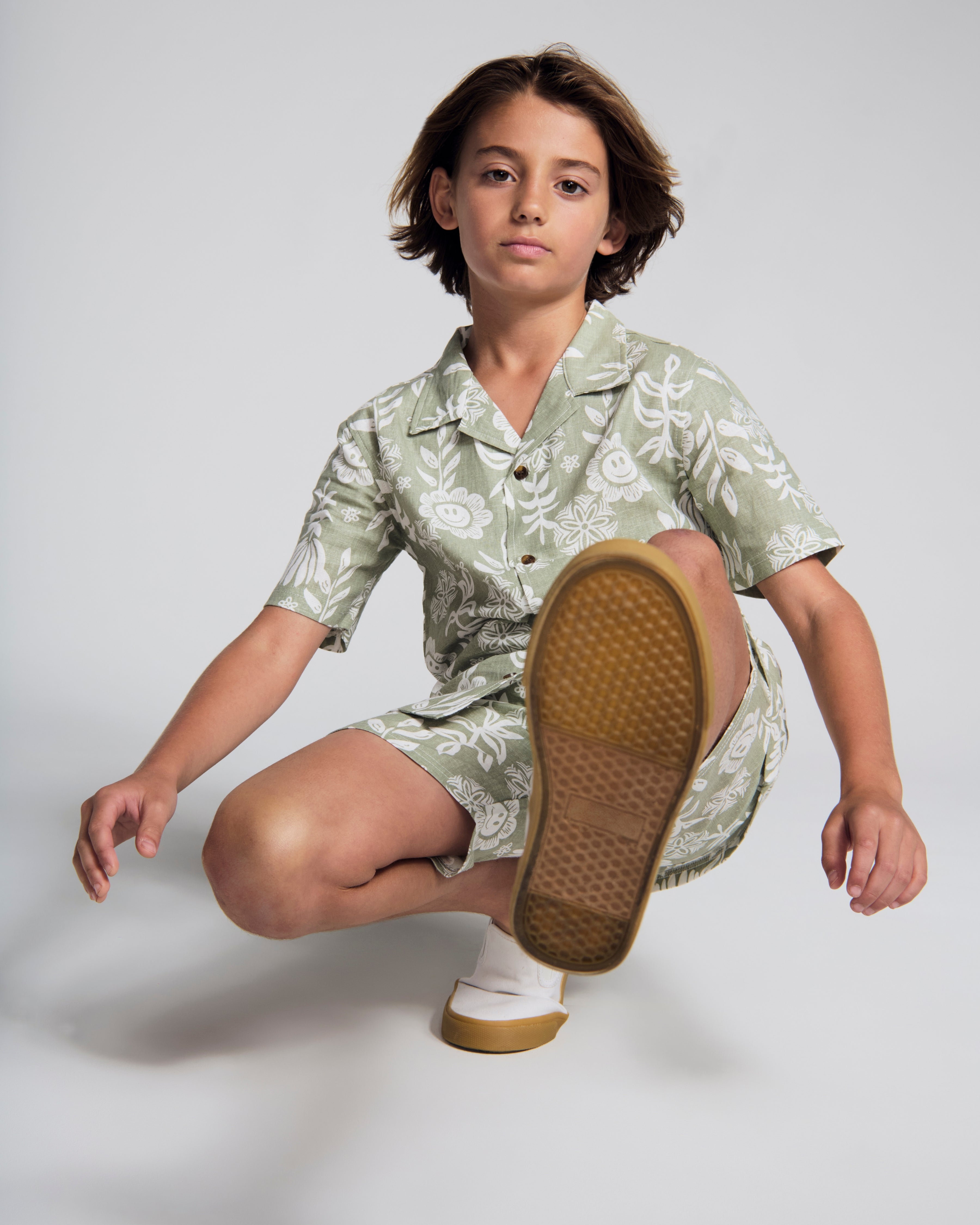 Linen Sage Sunflower Camp Collar Shirt on a model posing, featuring floral print and relaxed fit, perfect for Spring and Summer.