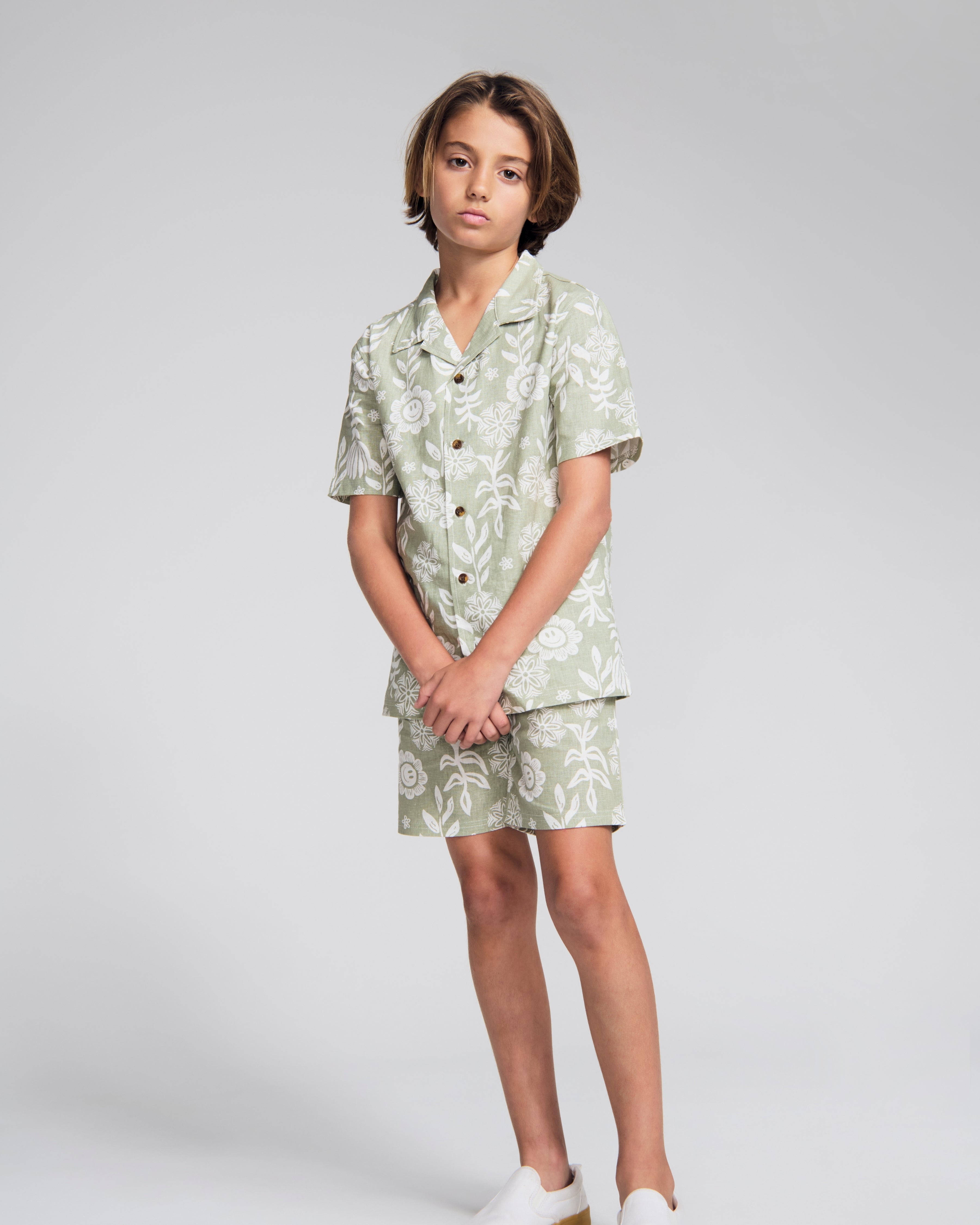 Linen Sage Sunflower Resort Short worn by a child, showcasing a stylish floral print and breathable design.