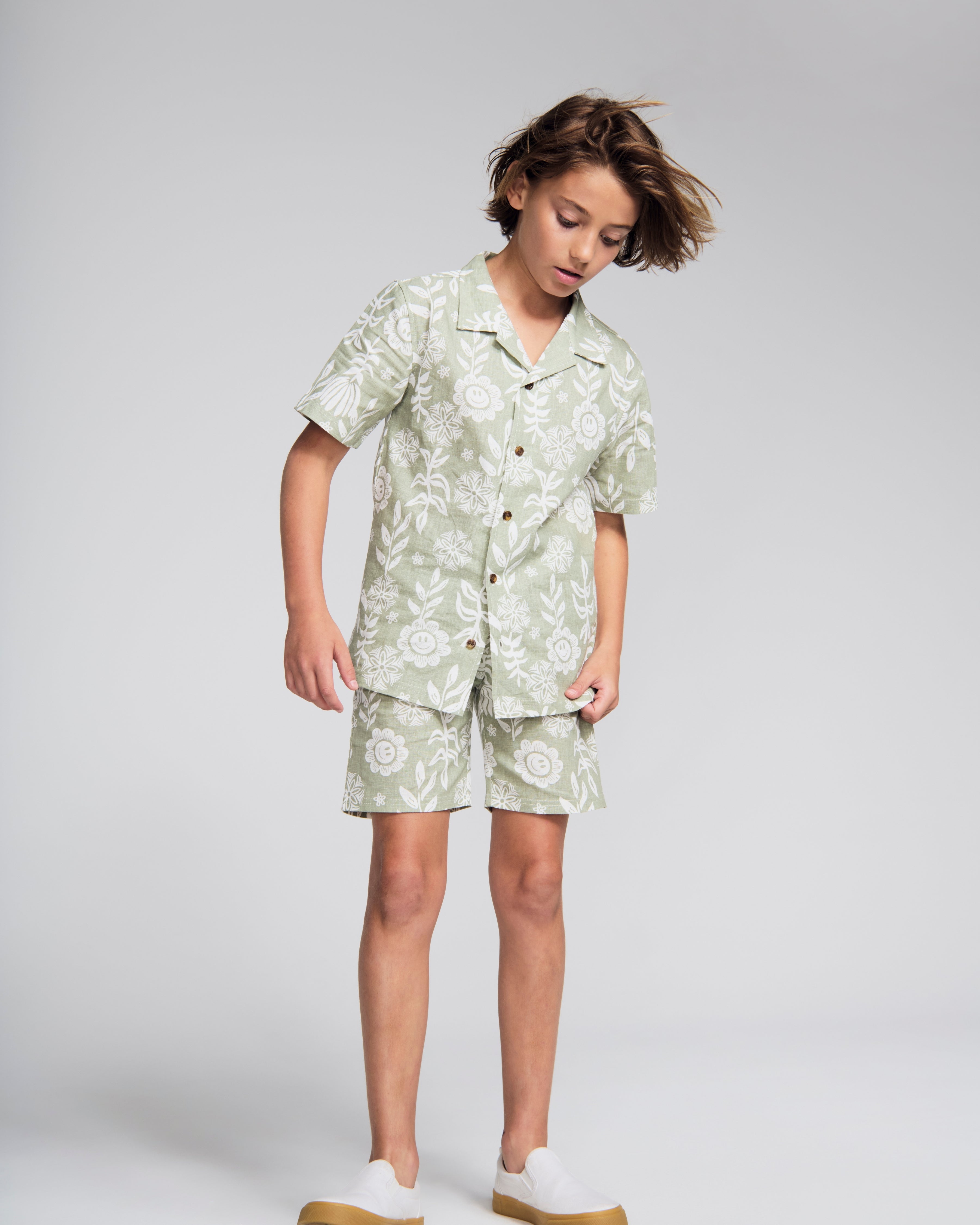 Linen Sage Sunflower Resort Short worn by a child, featuring a cheerful sunflower print, perfect for sunny days.
