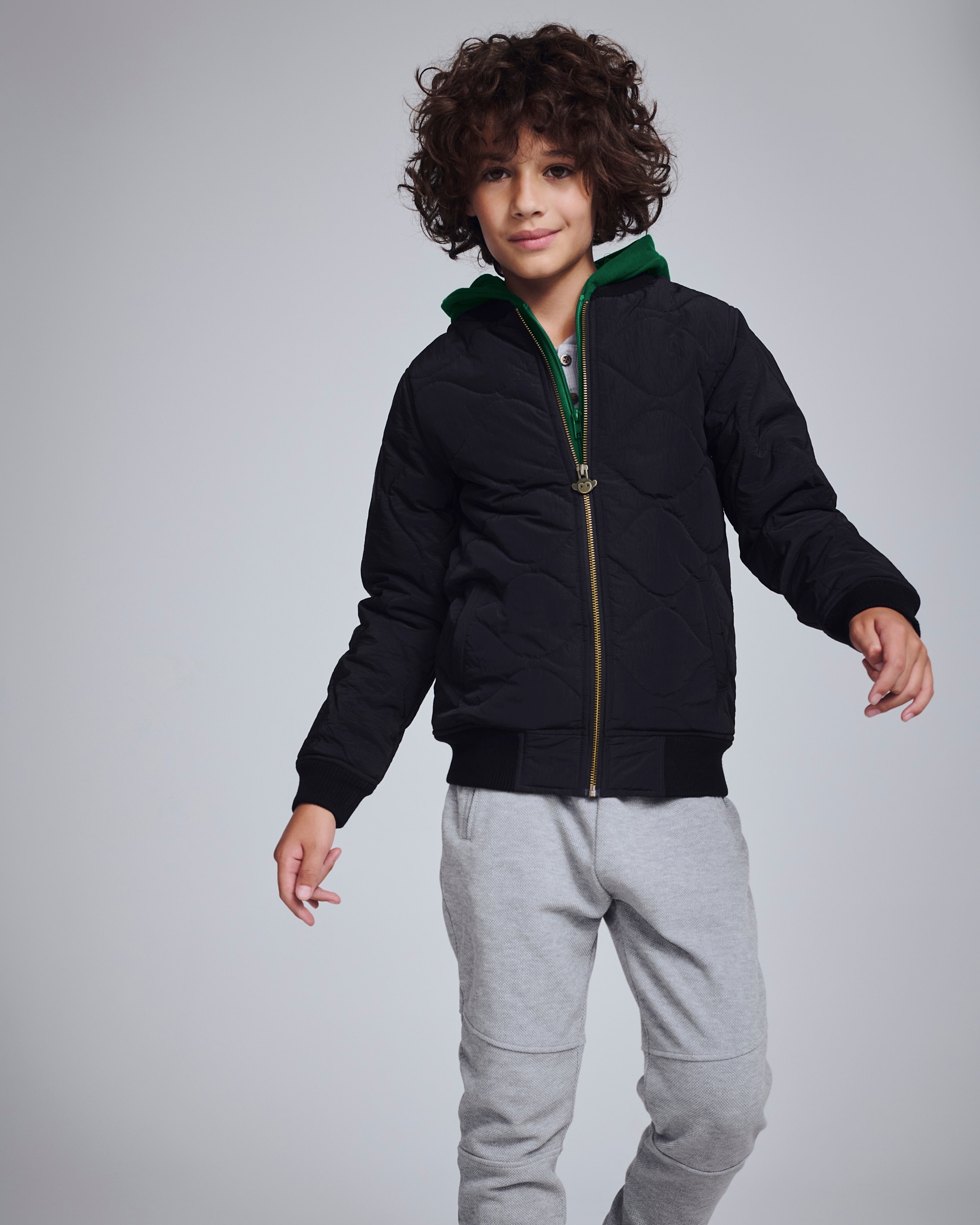 Boy wearing Novelty Grey Heather Sideline Sweatpants with a black jacket, showcasing a stylish and comfortable outfit.