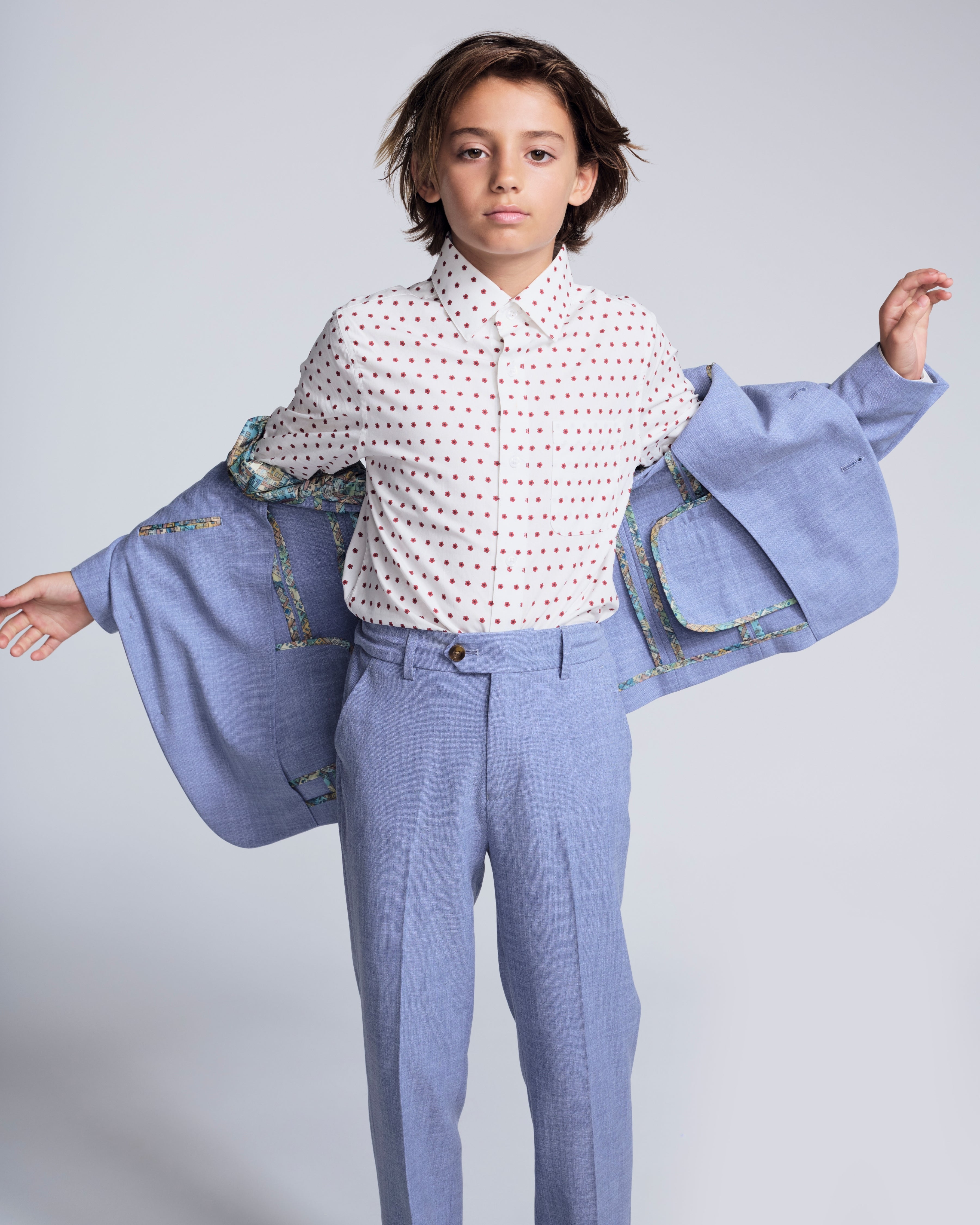 Child wearing Pacific Blue Stretchy Mod Suit with a polka dot shirt, showcasing tailored jacket and pants.