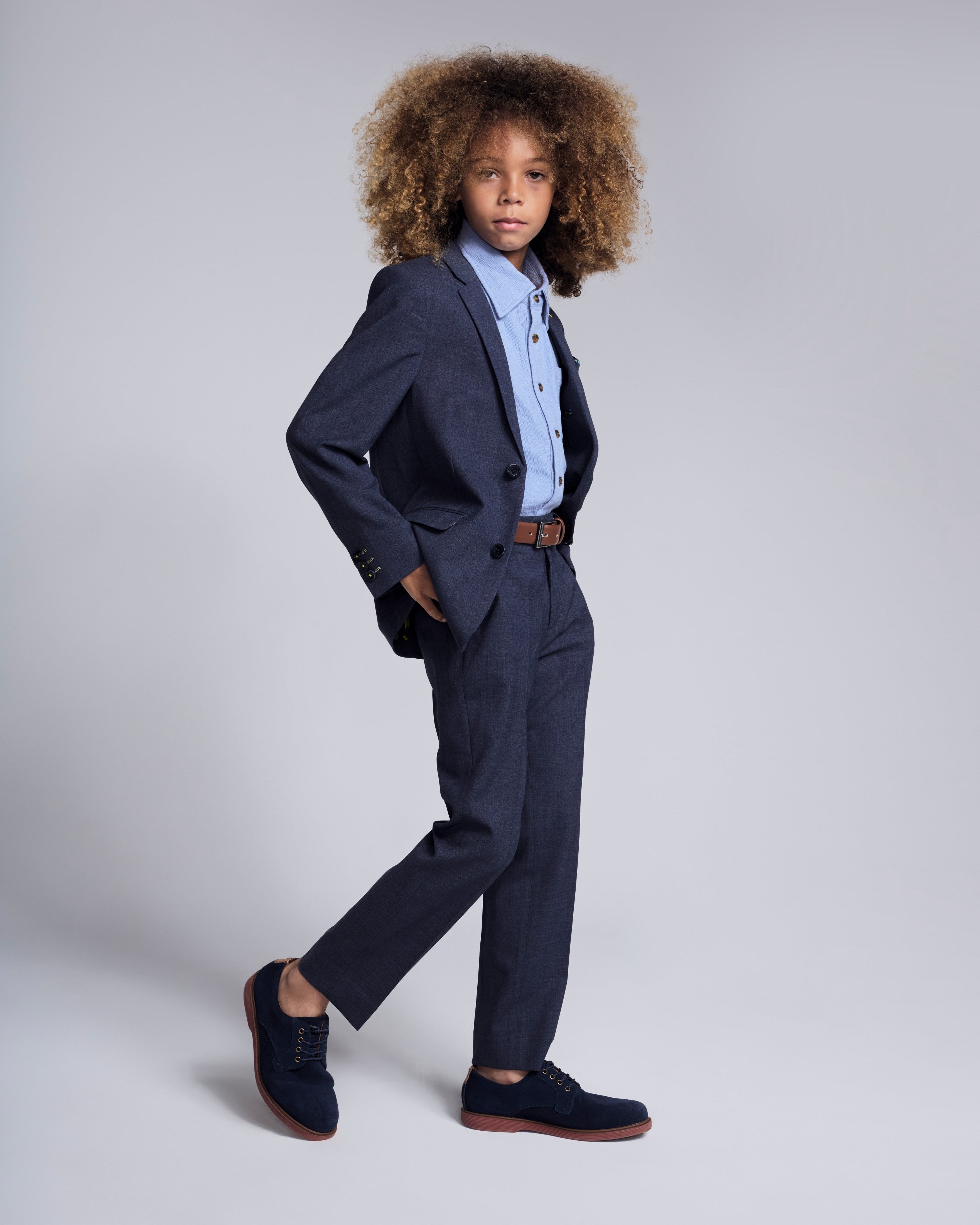 Boy wearing a Peacoat Stretchy Mod Suit with a lined jacket and skinny-leg pants, styled for a special occasion.