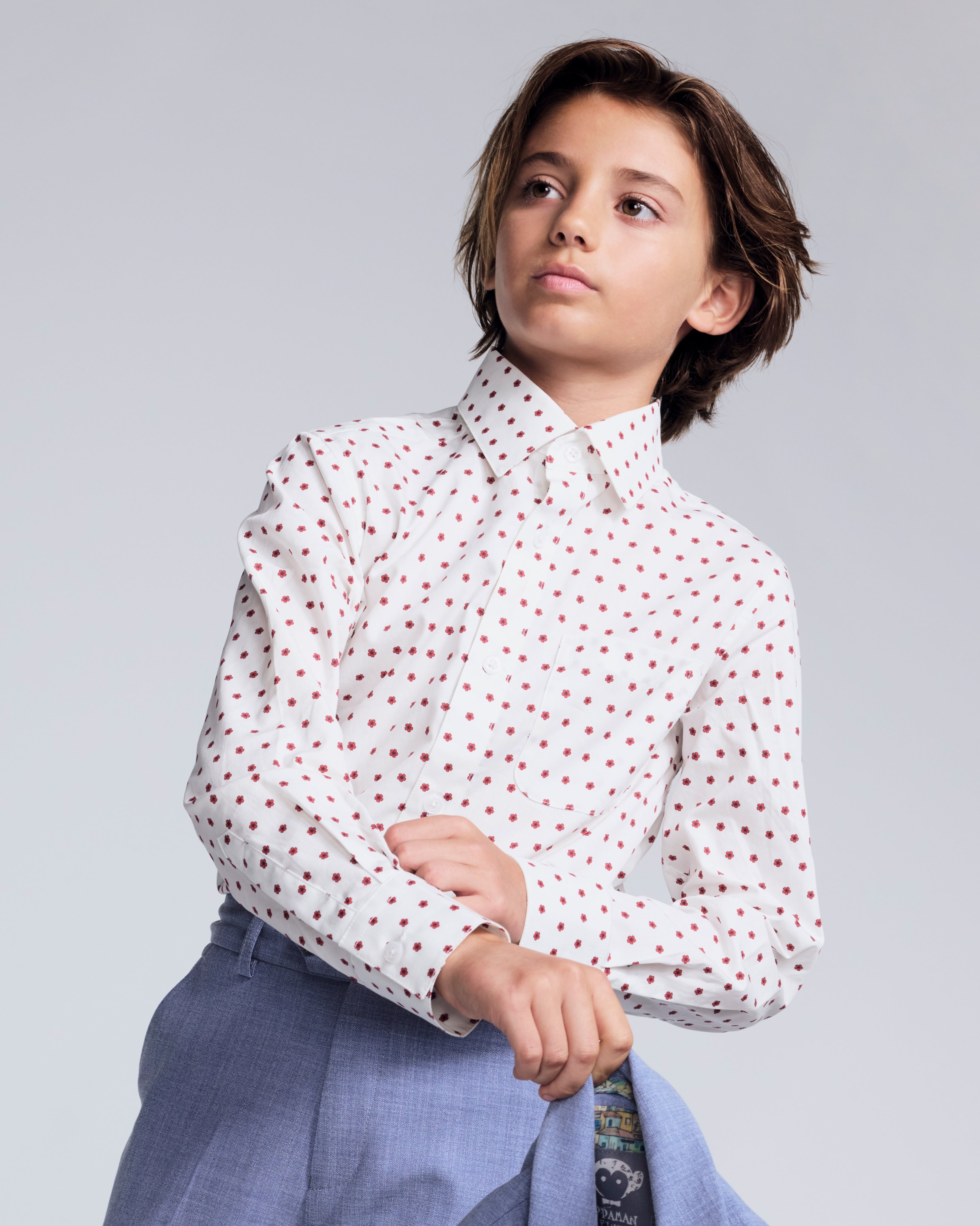 Boy wearing a stylish Red Hibiscus Standard Button Down Shirt with a polka dot pattern.