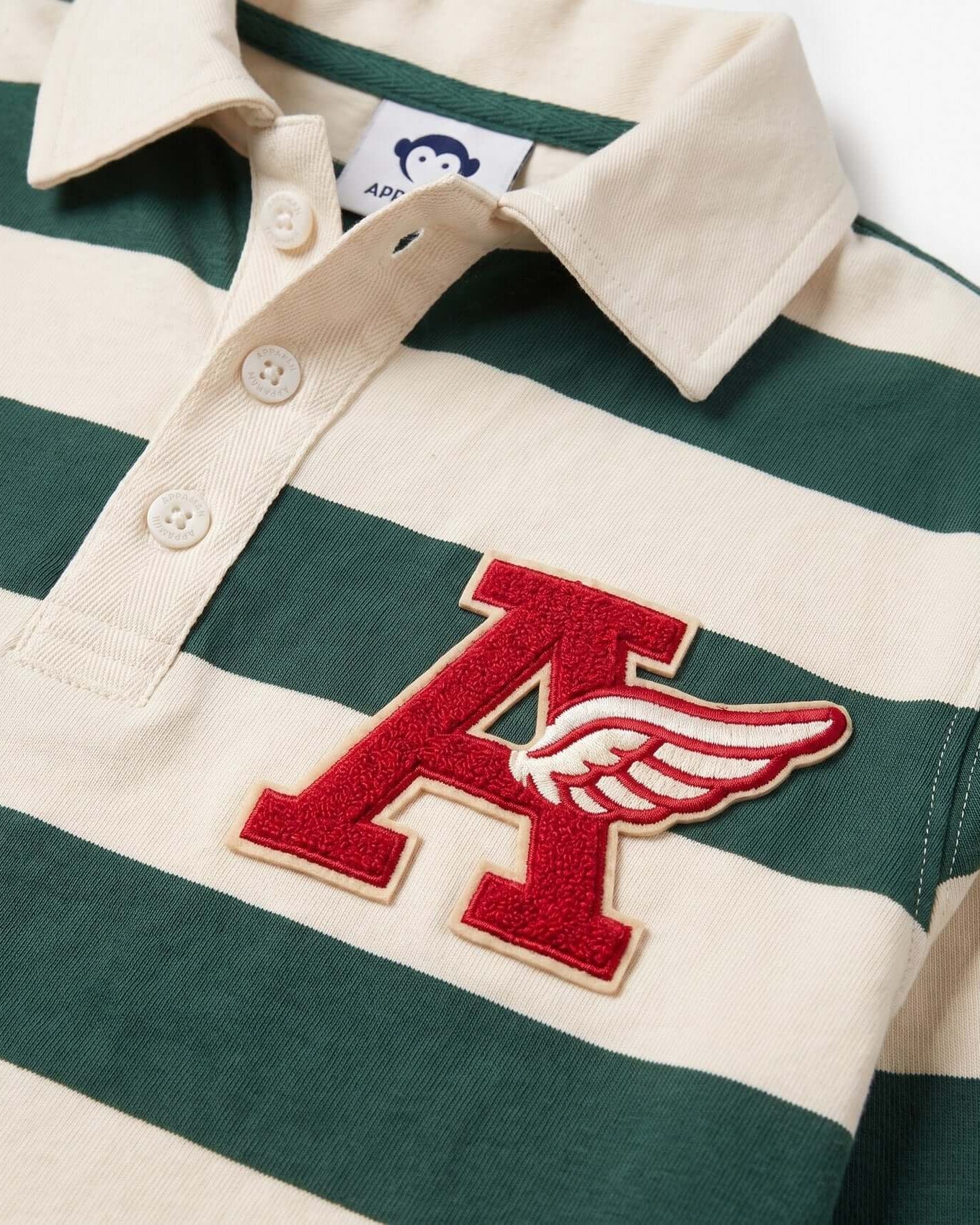 Green and white striped polo shirt with a red 'A' logo on a plain background
