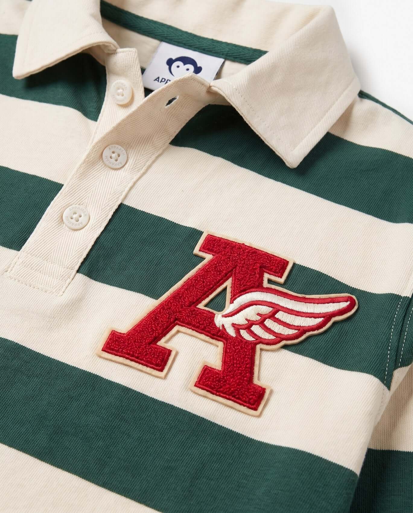 Green and white striped polo shirt with a red 'A' logo on a plain background