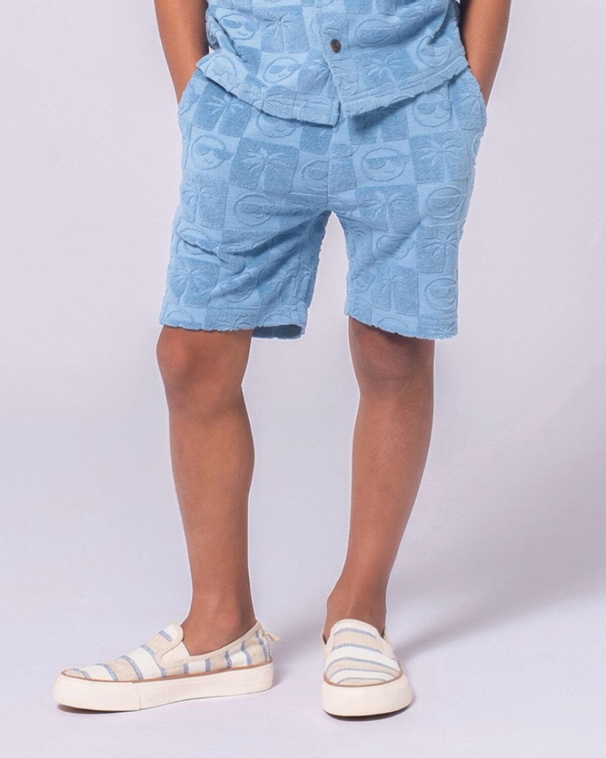 Blue Resort Terry Shorts for kids, featuring playful palm trees and smiley faces in a soft and lightweight fabric.