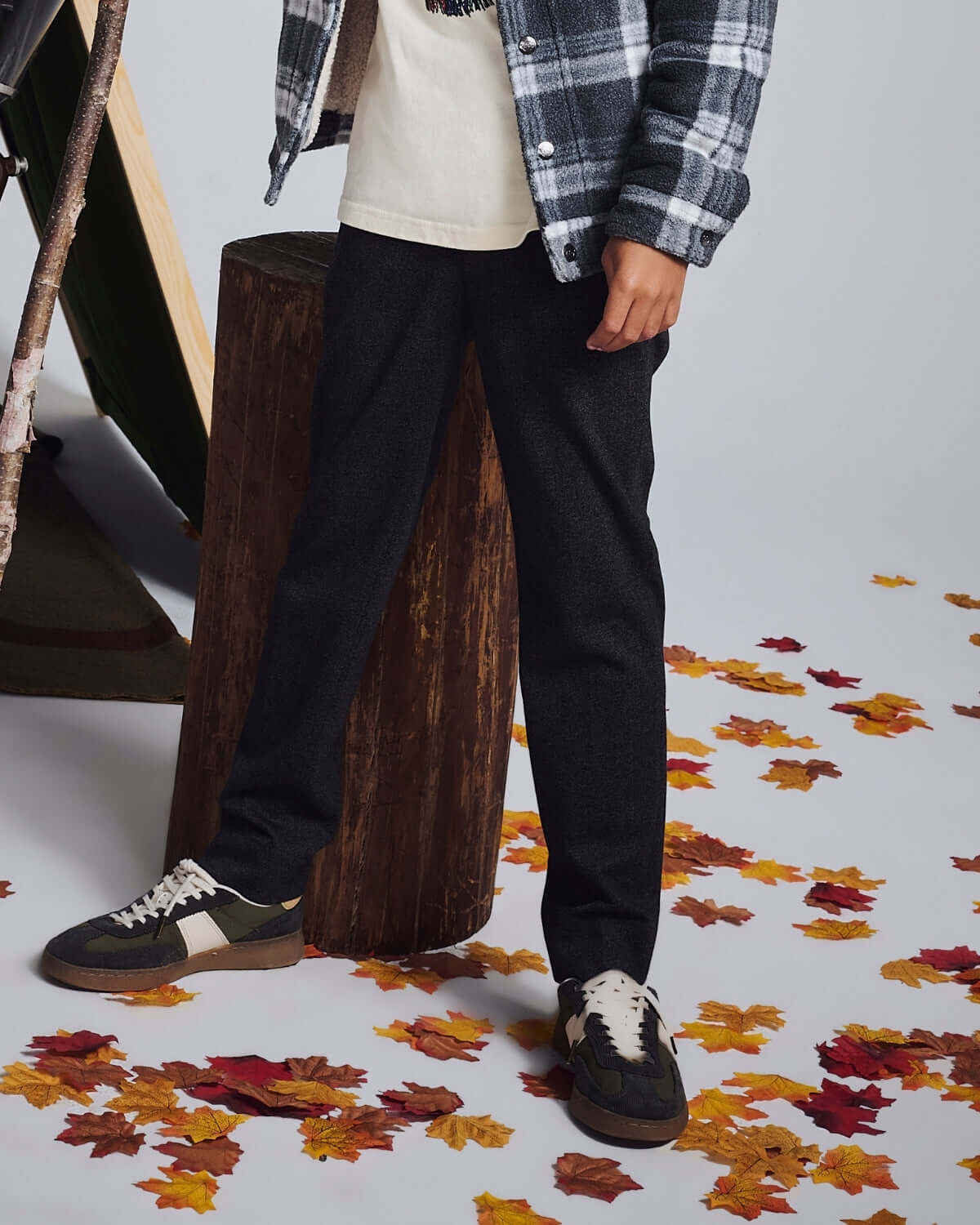 Tweed Everyday Stretch Pants displayed on a child against a backdrop of autumn leaves and a wooden backdrop.