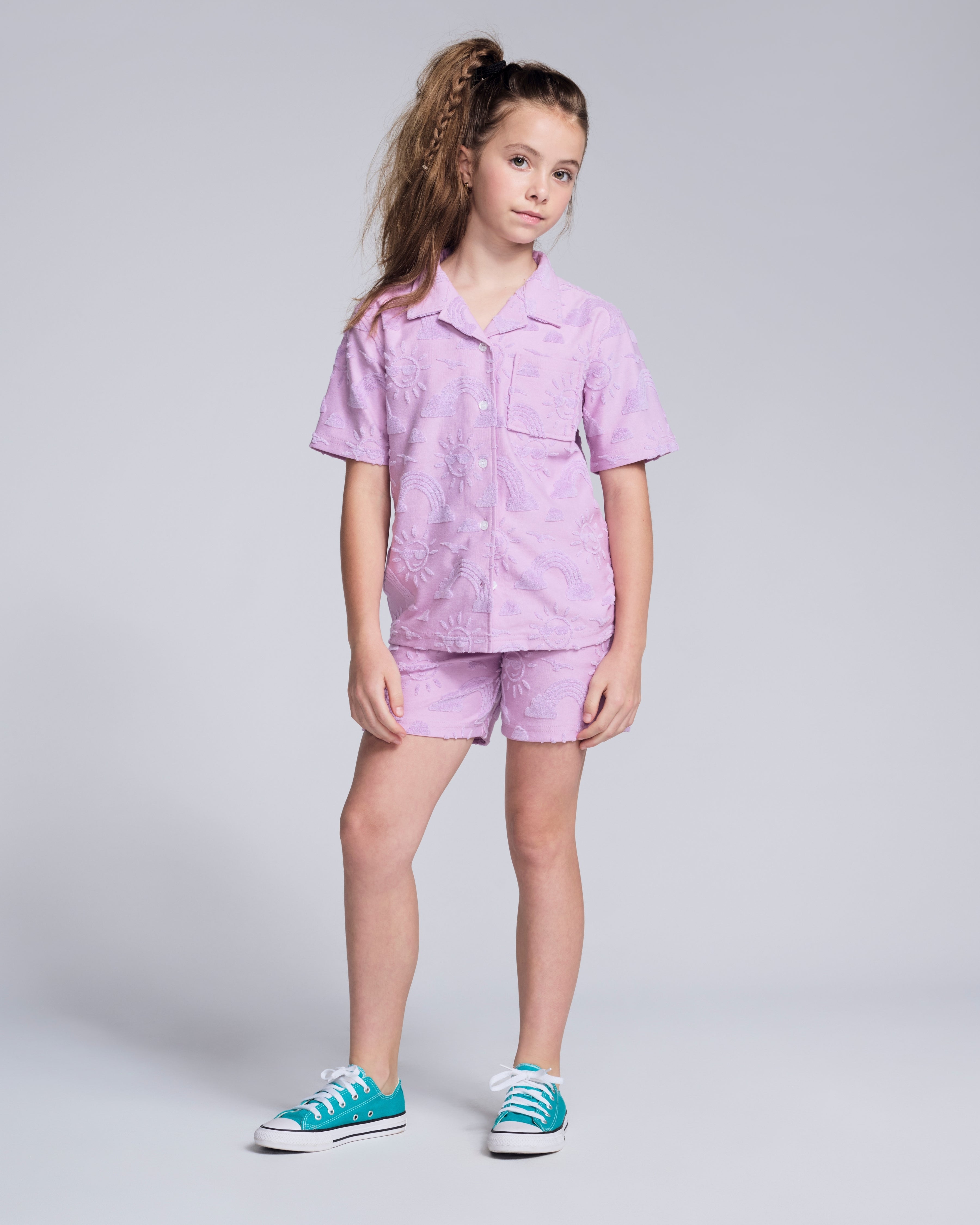 Sunny Days Lilac Resort Shirt on a young girl, paired with matching shorts, showcasing cheerful prints.