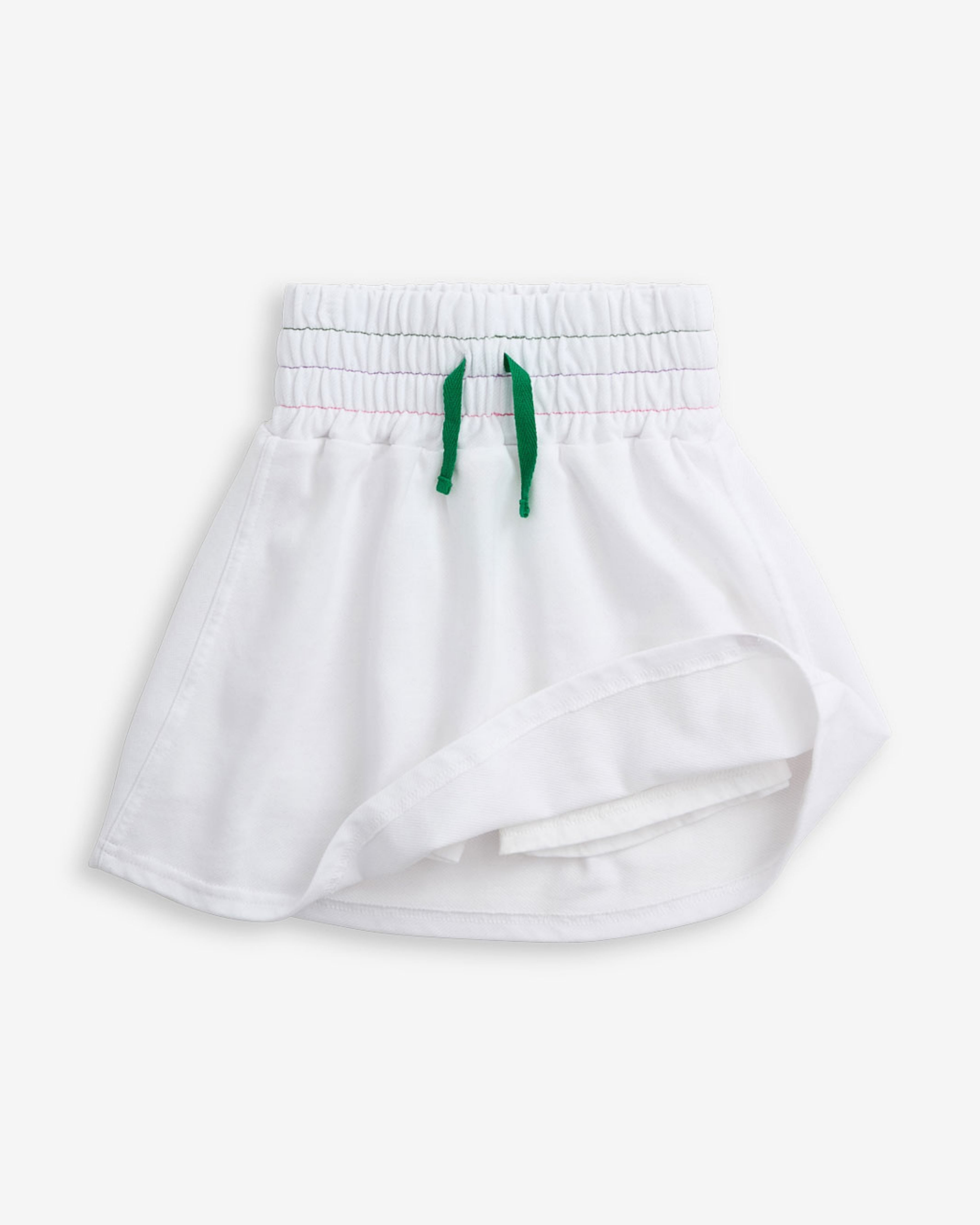 White Terry Laney Skort featuring a smocked waistband and tie front bow detail, perfect for active days.