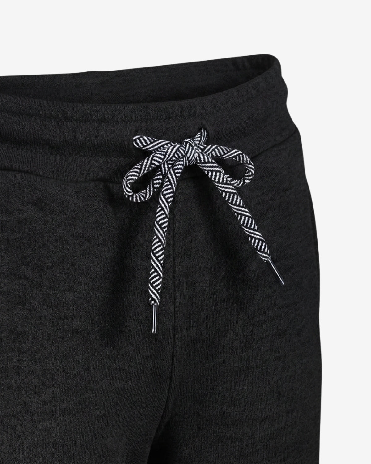 Close-up of dark charcoal gray sweatpants with a black and white patterned drawstring bow at the waistband, shown against a plain light background.