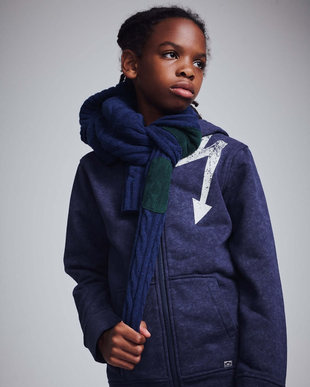 Washed Navy Bolt Strivers Hoodie worn by a young model with a stylish scarf.