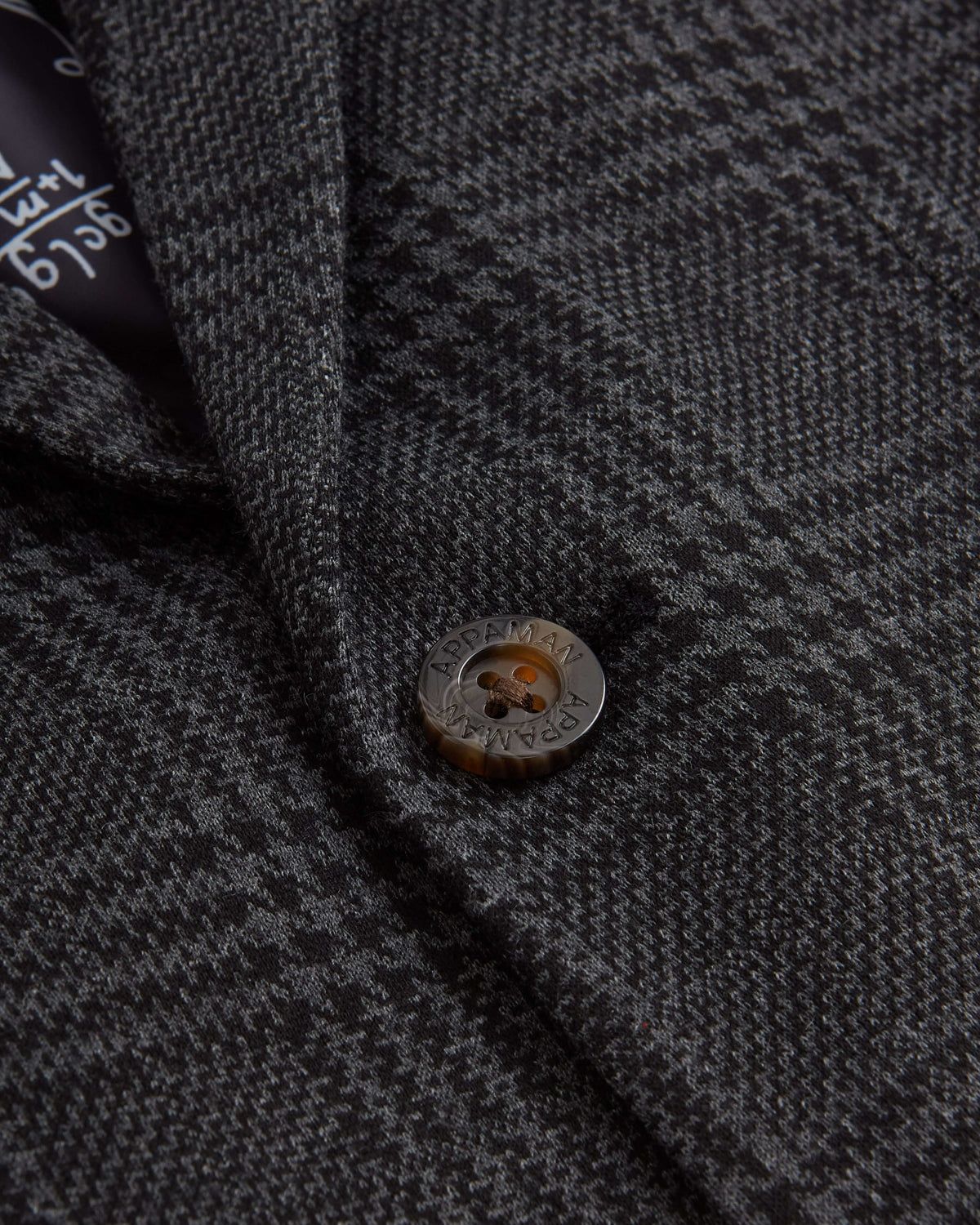 Close-up of the button detail on the Professor Plaid Club Jacket, showcasing its stylish plaid design.