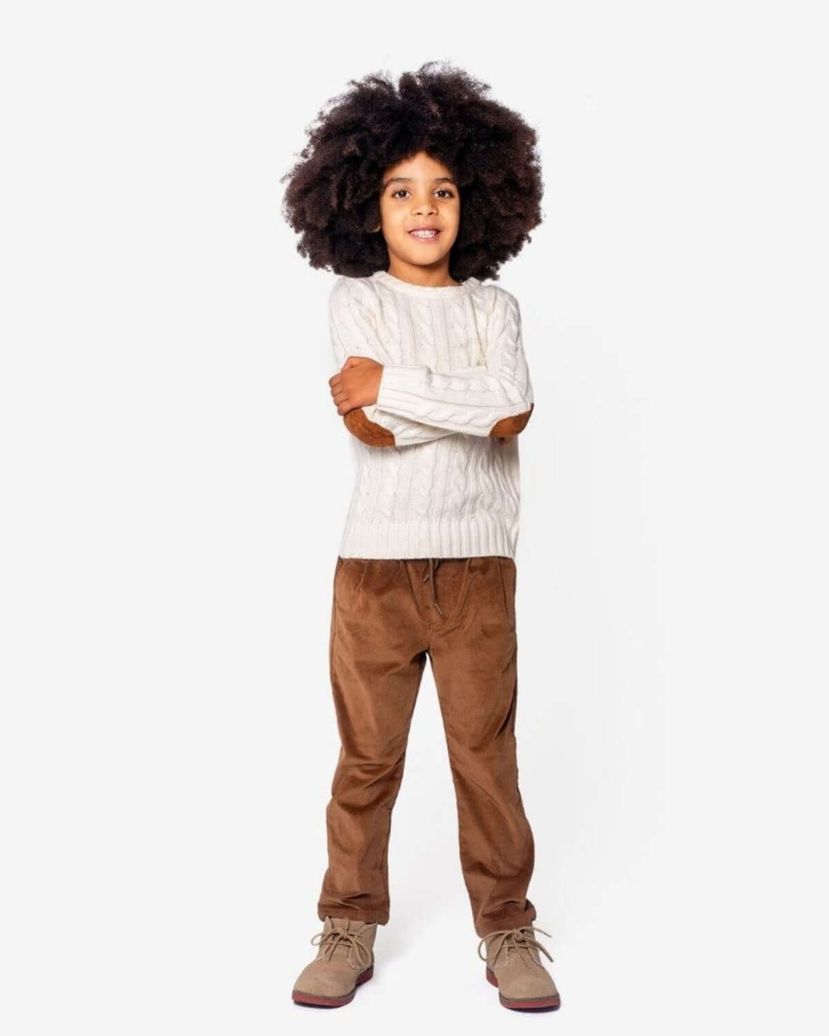 British Khaki Club Pants model wearing a stylish outfit with a cable-knit sweater and corduroy slacks.