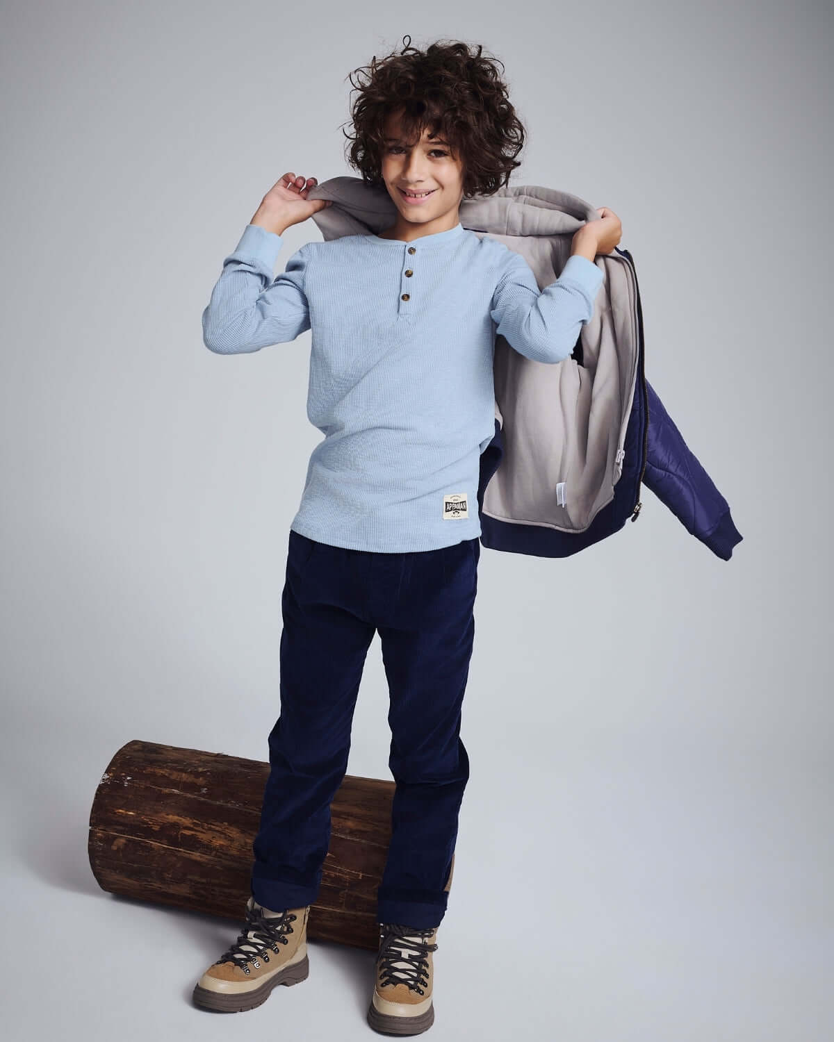Boy wearing Navy Blue Club Pants with a light blue long-sleeve shirt and a jacket outdoors.