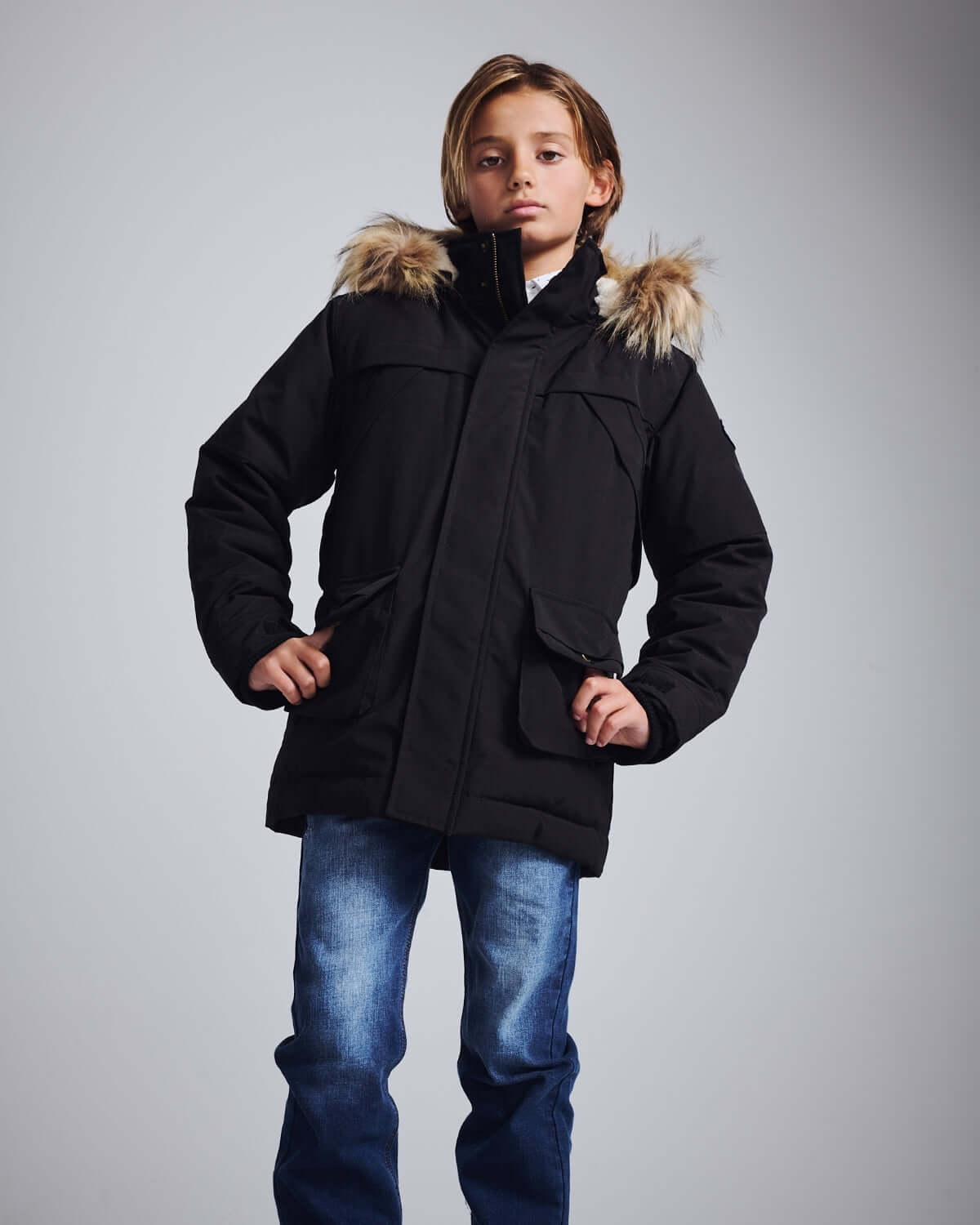 Black Denali Down Coat model showcasing a stylish winter jacket with fur-lined hood.