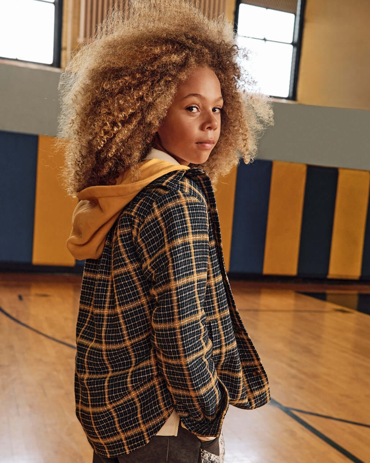 Evergreen Check Glen Flannel Hoodie in a stylish indoor basketball court setting.