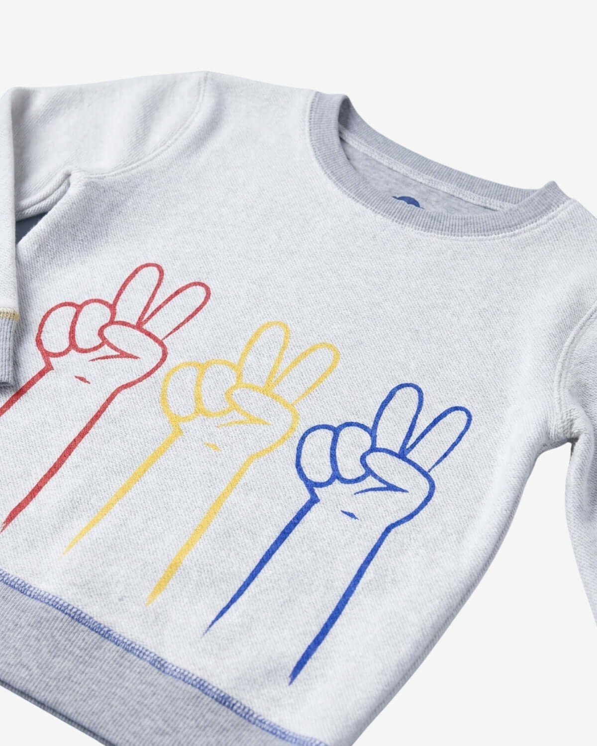 Gray sweatshirt with colorful peace sign designs on a white background