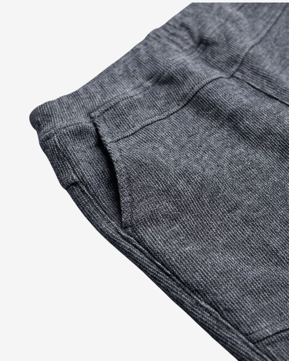 Close-up of gray pants with a pocket on a white background
