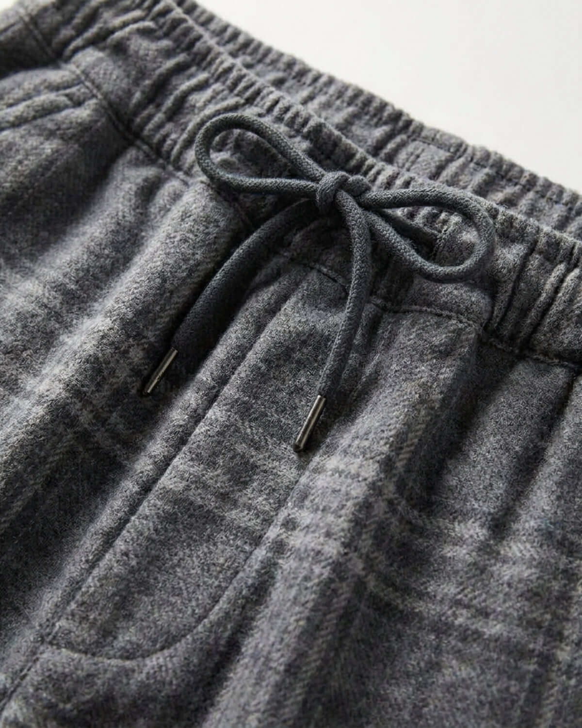 Gray sweatpants with a drawstring on a light gray background