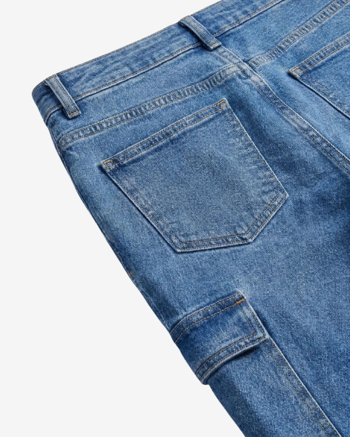 Close-up of blue denim jeans on a white background