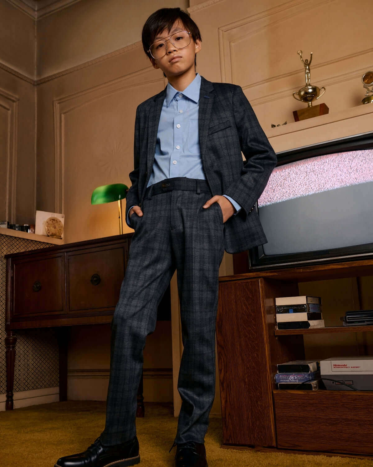 Gentleman's Plaid Stretchy Mod Suit worn by a young boy, showcasing stylish grey plaid pattern and modern fit.