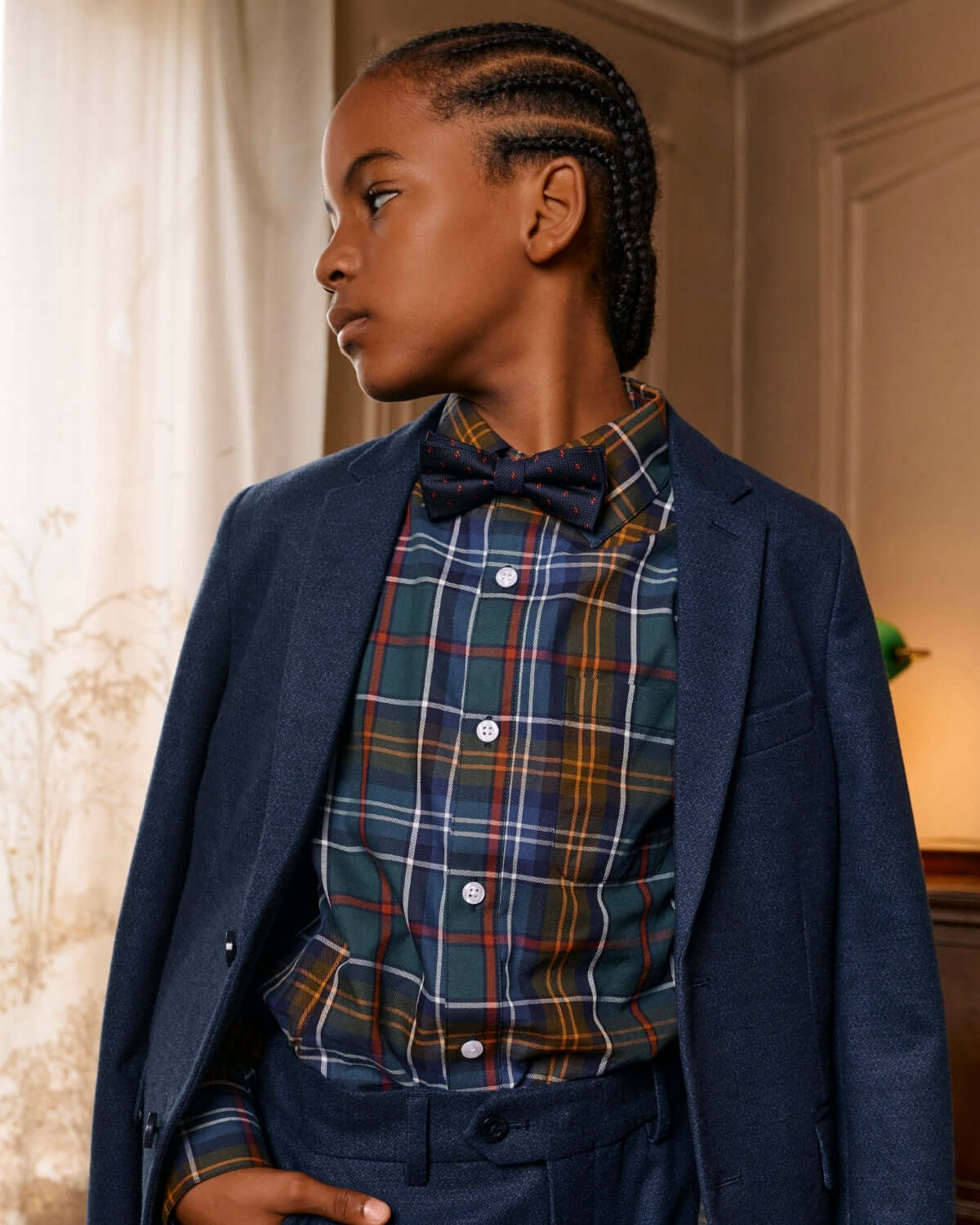 Boy wearing Navy Darts Bow Tie with plaid shirt and suit, showcasing stylish children's formal wear.
