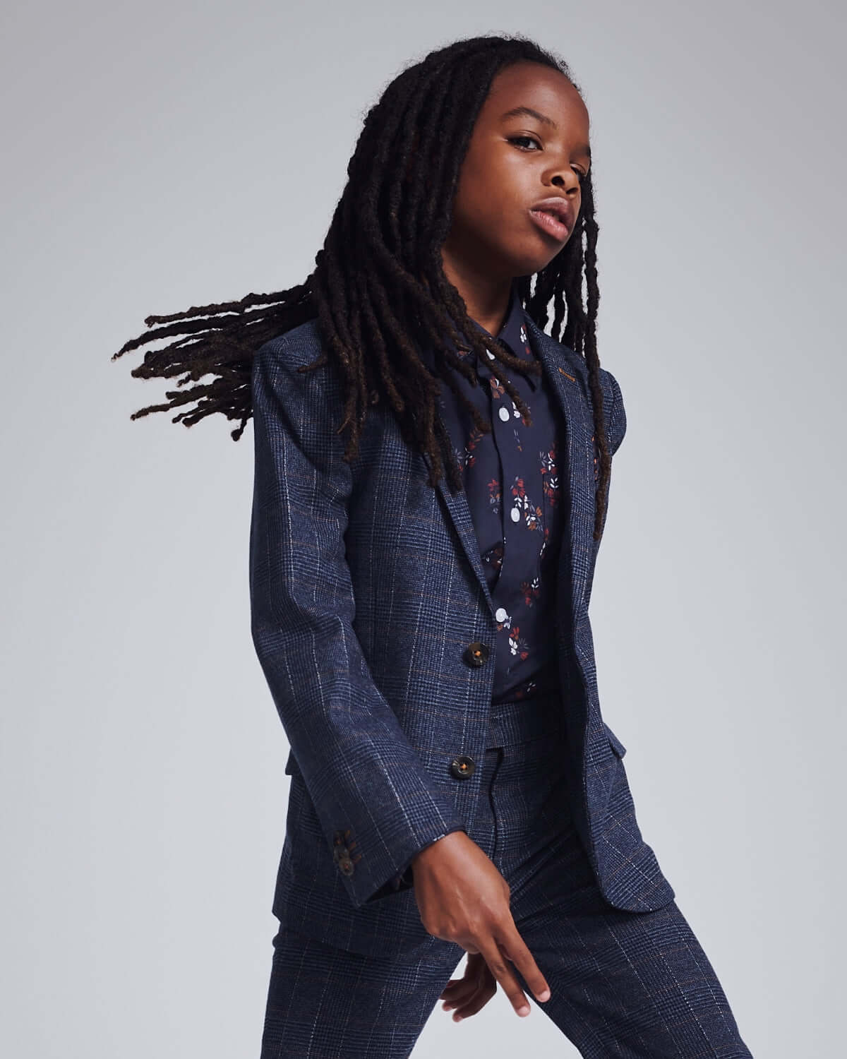 Gotham Plaid Stretchy Mod Suit worn by a stylish kid with long hair, showcasing a modern and bold look.