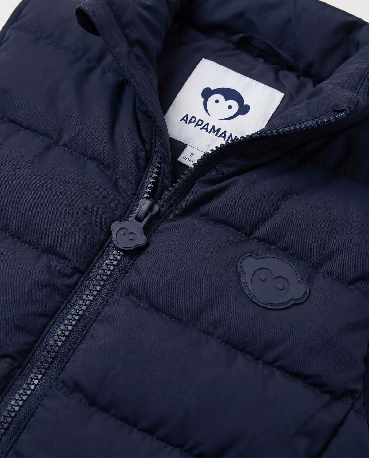 Close-up of the Dark Navy Packable Vest by Appaman featuring zip closure and logo detail.