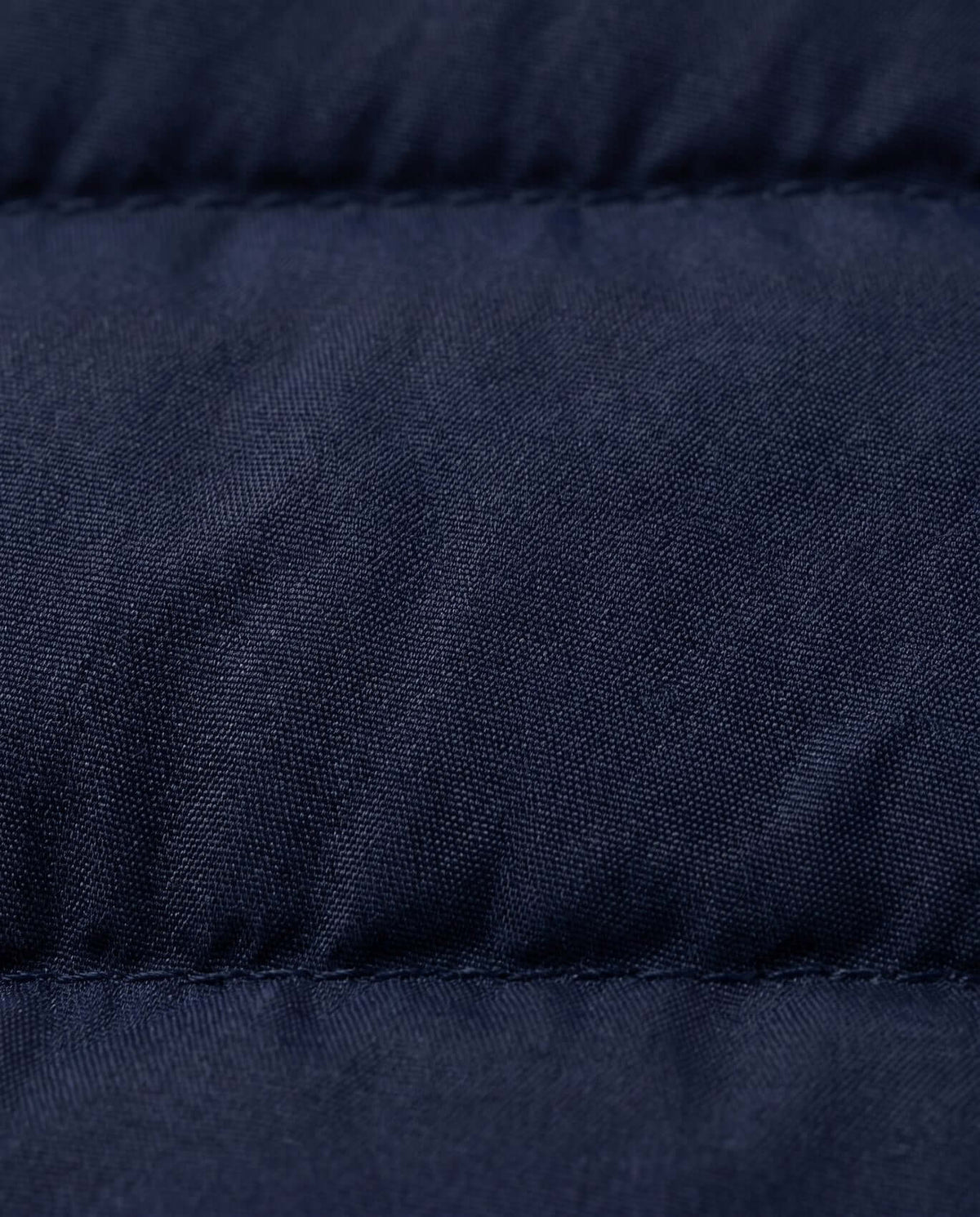Close-up of the fabric texture of the Dark Navy Packable Vest, showcasing its lightweight and durable material.