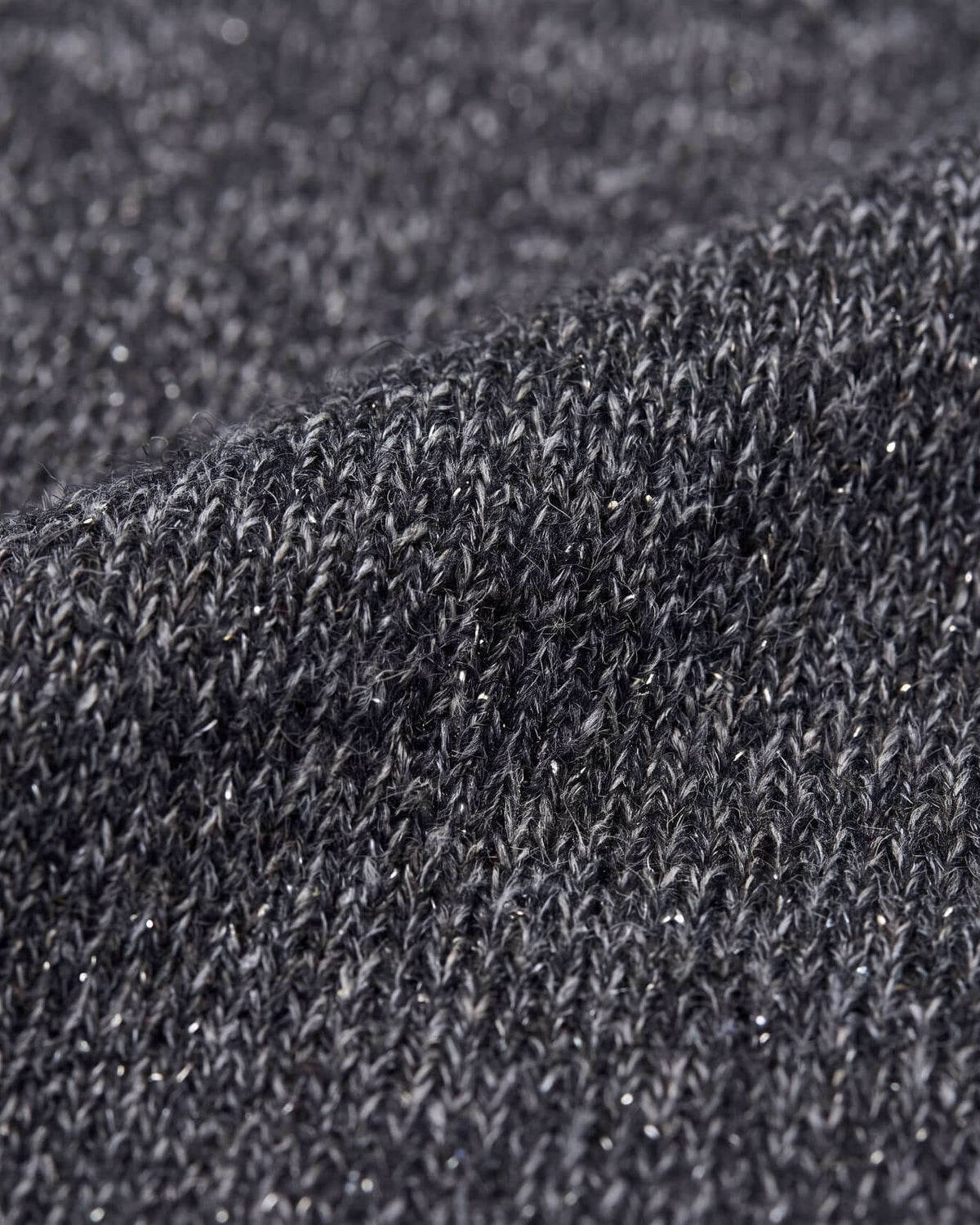 Close-up of the fabric texture showcasing the shimmer in the Black Glitter City Sweatshirt.