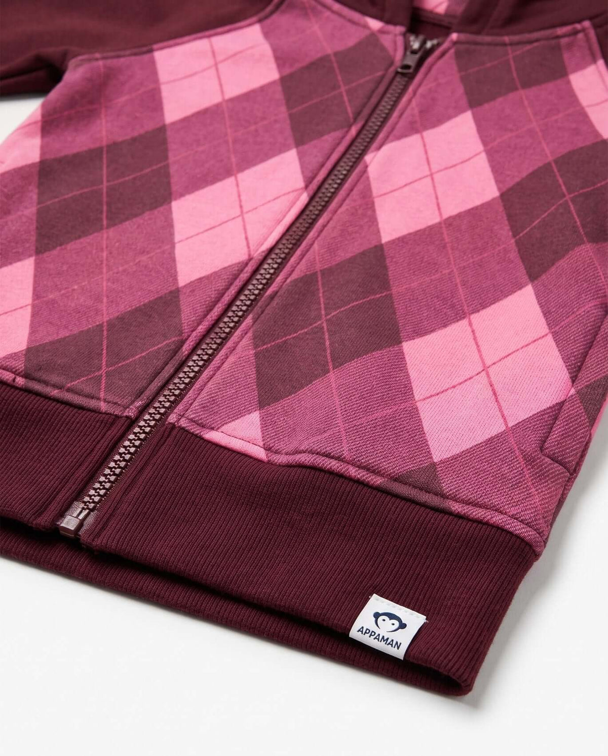 Berry Cozy Raglan Hoodie close-up showing pink argyle pattern and Appaman logo.