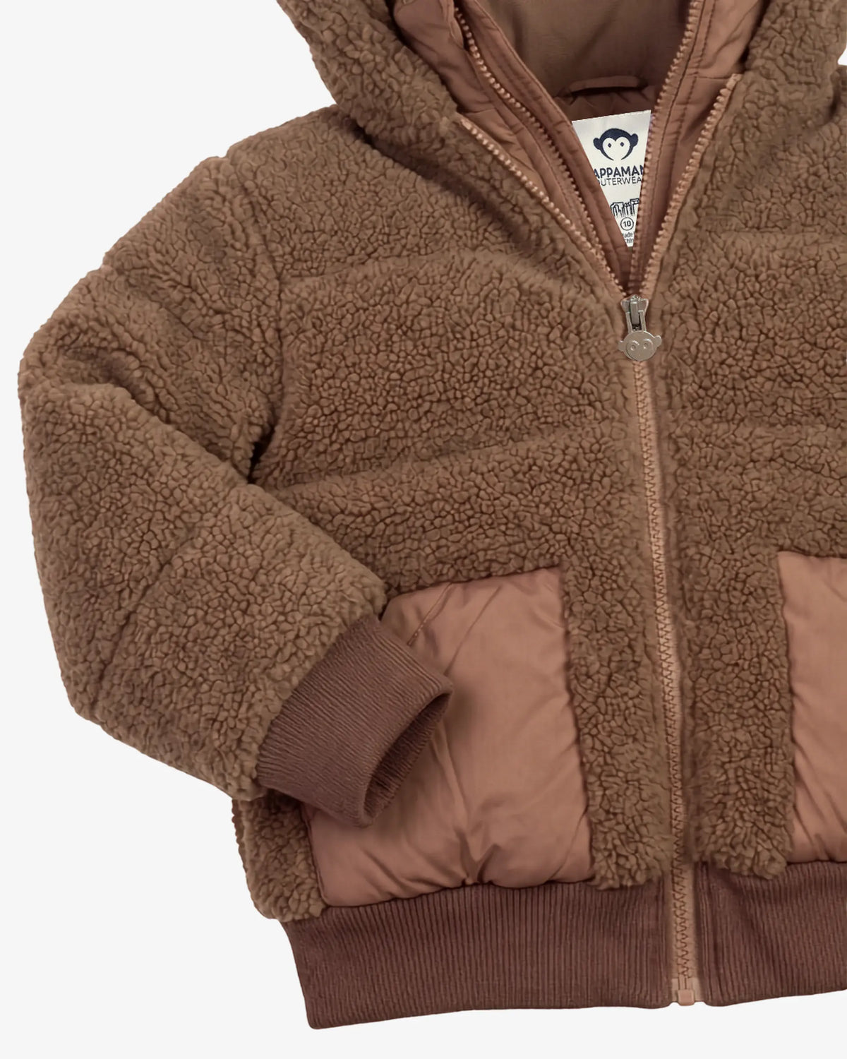 A close-up of a brown sherpa fleece zip-up jacket with quilted brown puffer panels on the front and ribbed brown cuffs and hem.