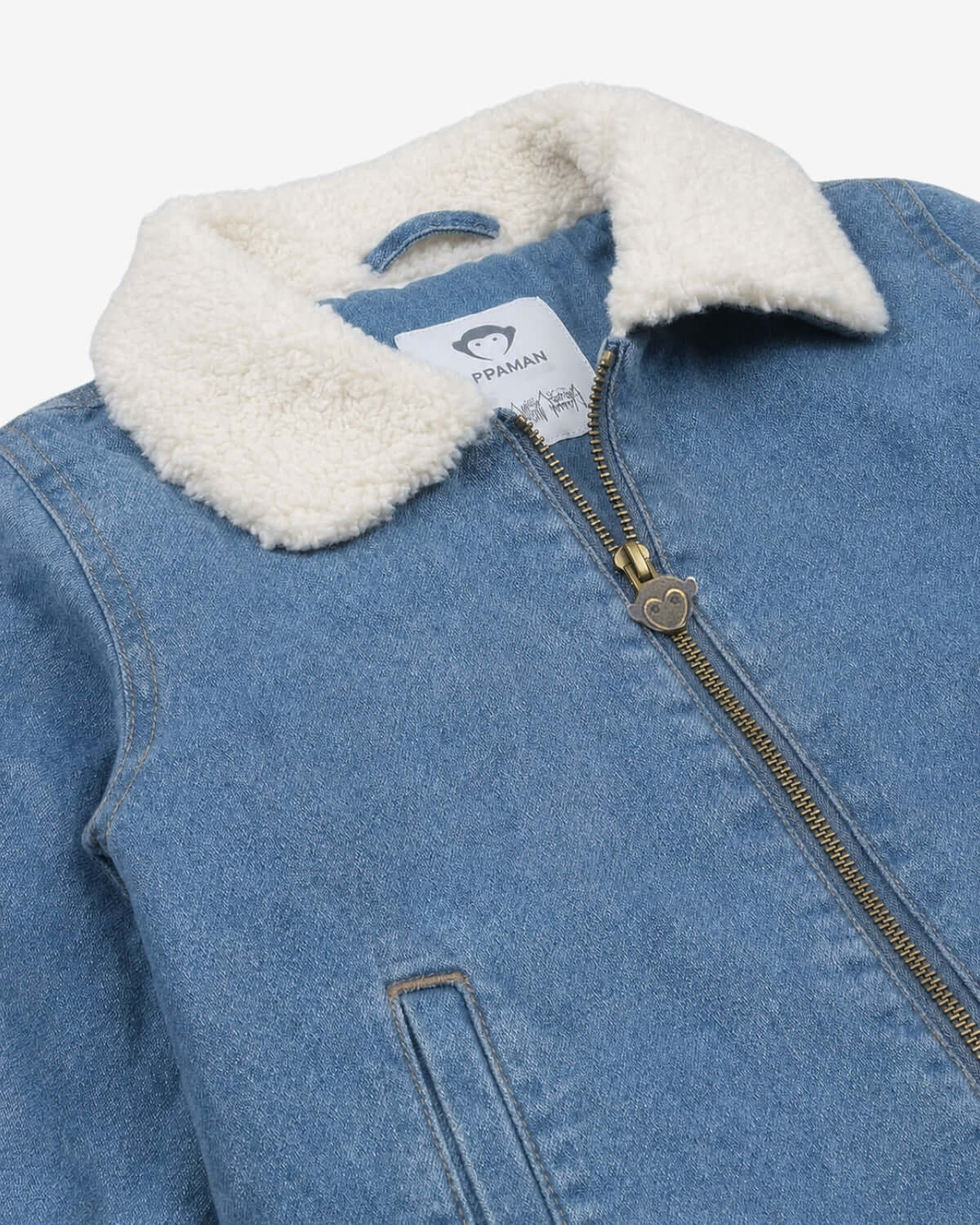 Blue denim jacket with white sherpa lining on a white background