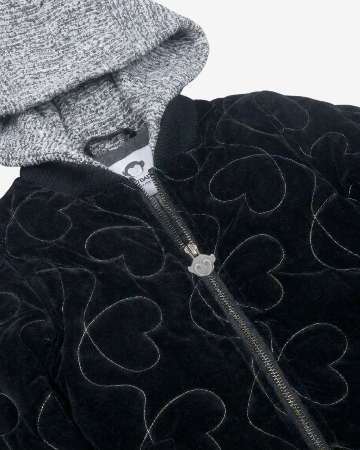 Black jacket with heart patterns and a gray beanie on a white background