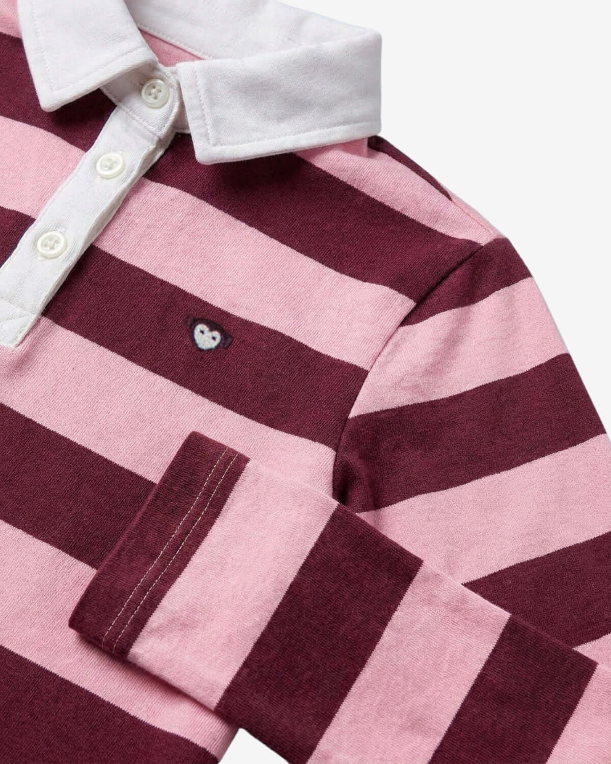 Close-up of a pink and maroon striped shirt with white collar and buttons.