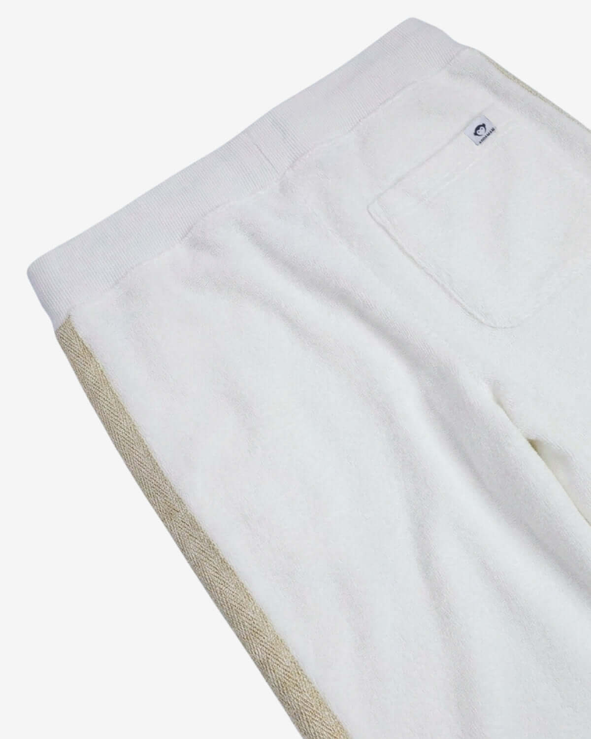 White towel with beige trim on a white background
