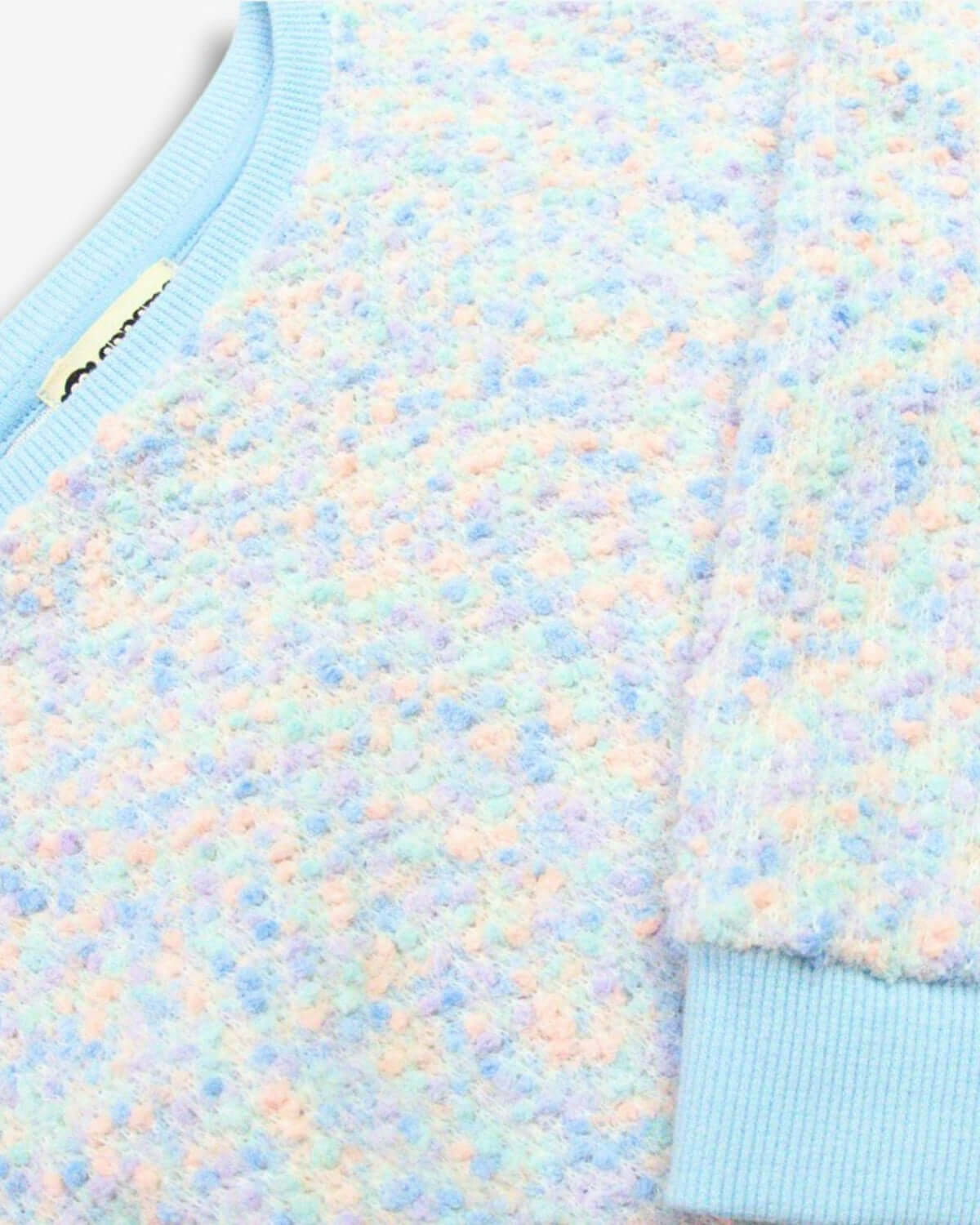 Multi Laurel Top featuring soft multicolor confetti texture and blue arm cuffs.