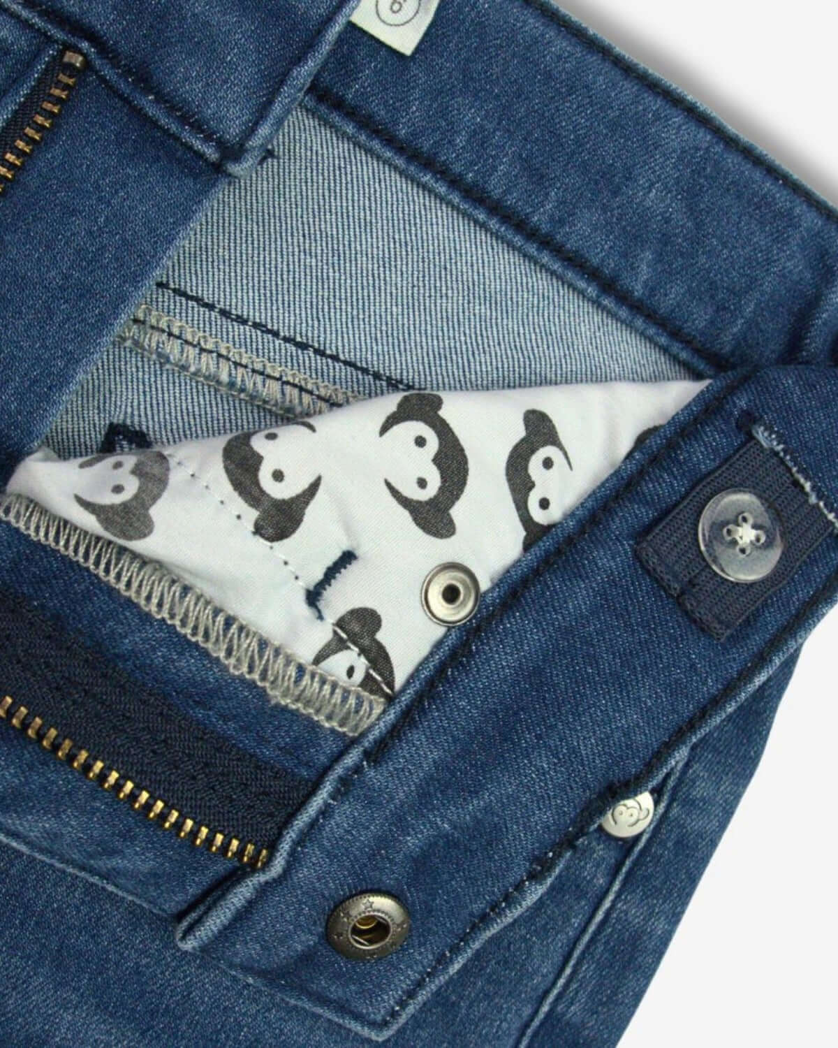 Medium Wash Liana Pant close-up showcasing the unique inner lining and zipper details of the wide-legged jeans.