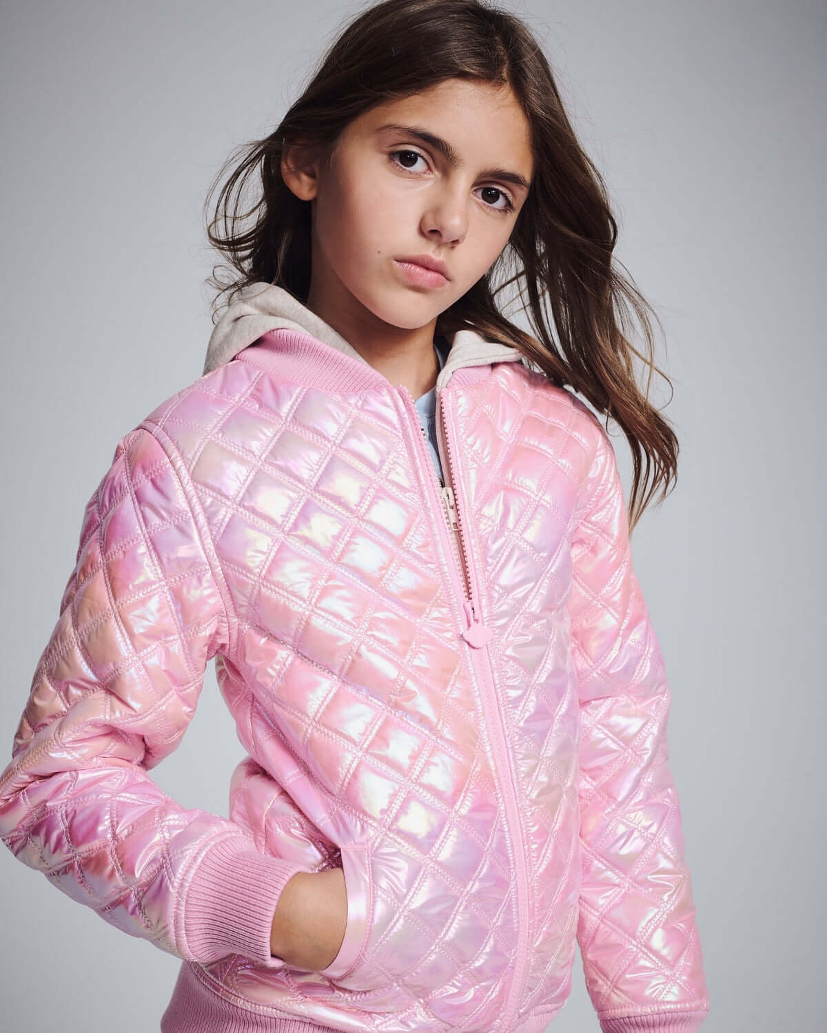 Pink Shine Bomber Jacket featuring shiny pink quilted exterior and cozy oatmeal hood for kids.