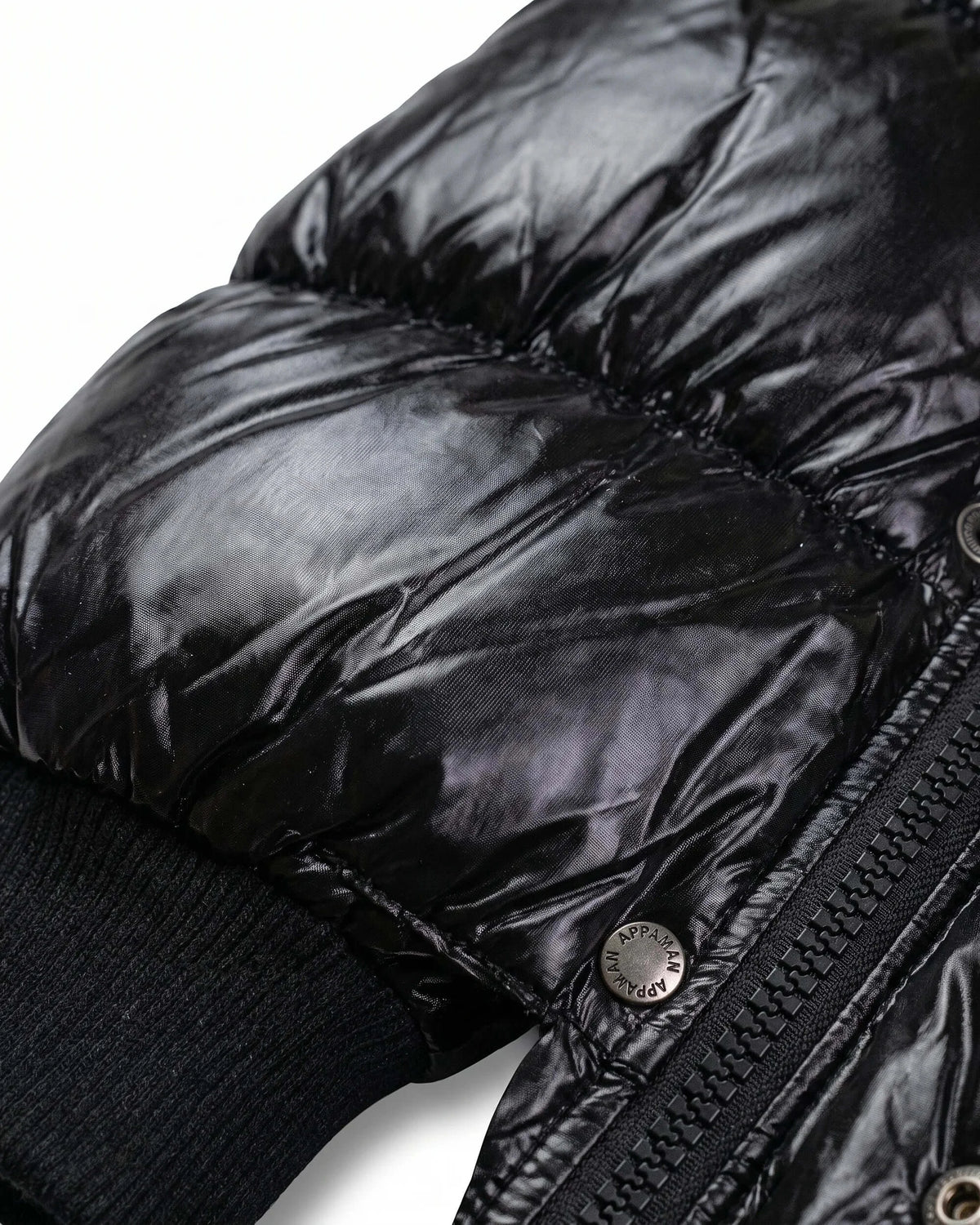 Close-up of the Black Glitter Puffy Coat showcasing the shiny black fabric and quilted texture.
