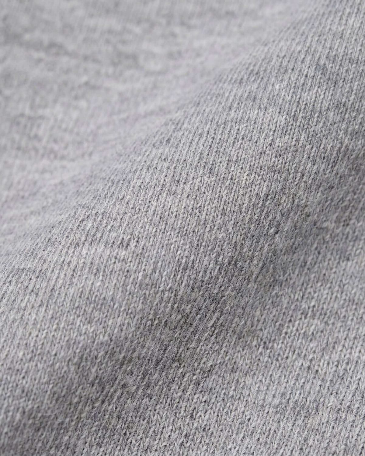 Close-up of soft heather grey fabric for the Heather Grey Ruffle Tee, showcasing its texture and comfort.