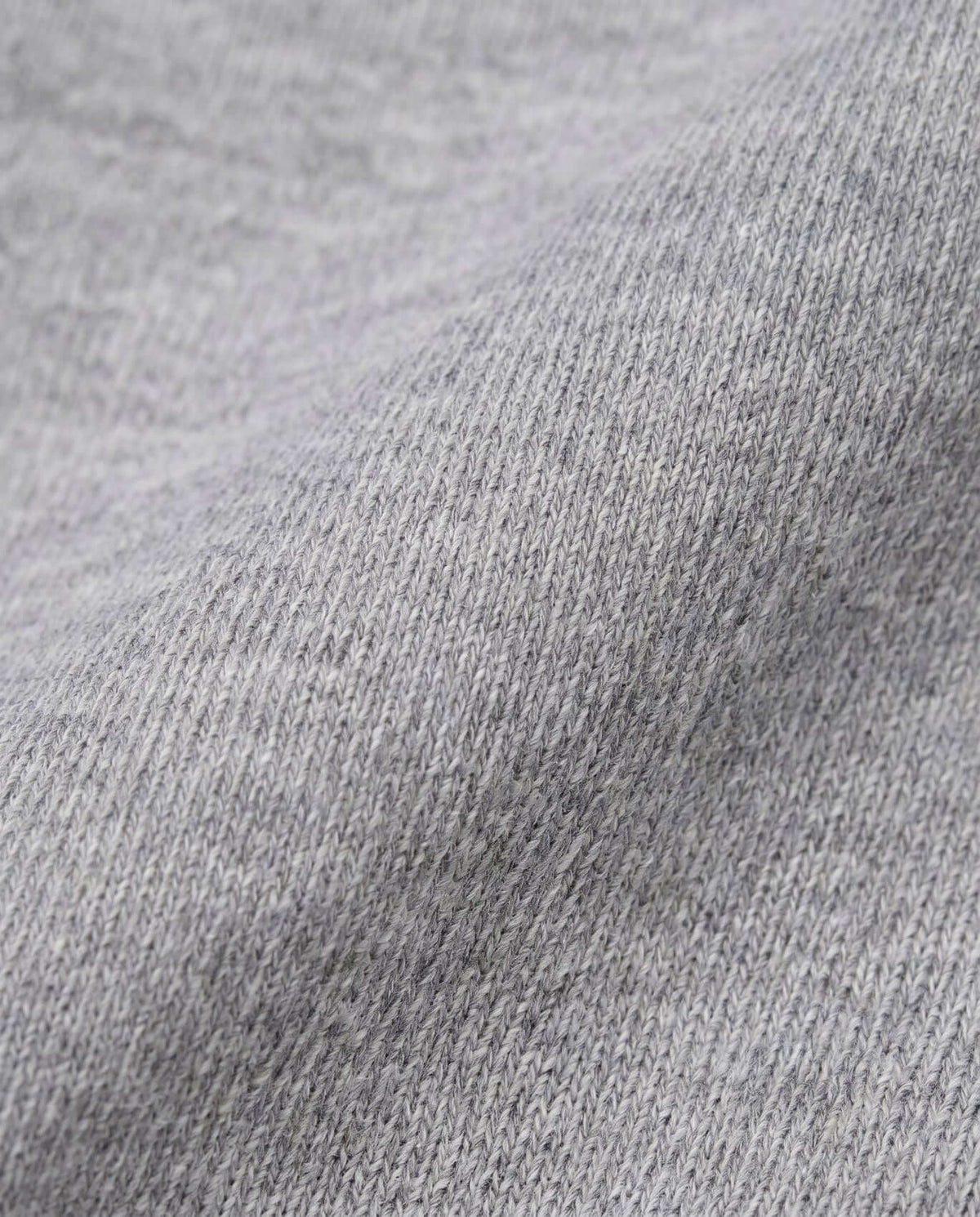 Close-up of soft heather grey fabric for the Heather Grey Ruffle Tee, showcasing its texture and comfort.