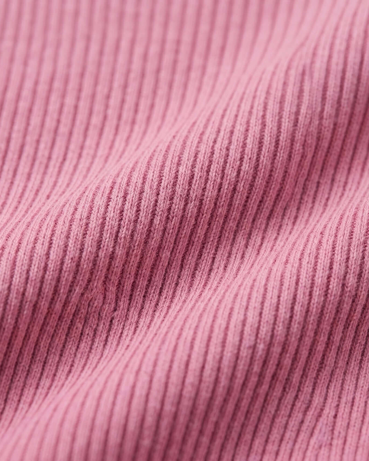 Close-up of the soft ribbed fabric in Dusty Pink Vanna Half Zip Sweater, showcasing texture and color.