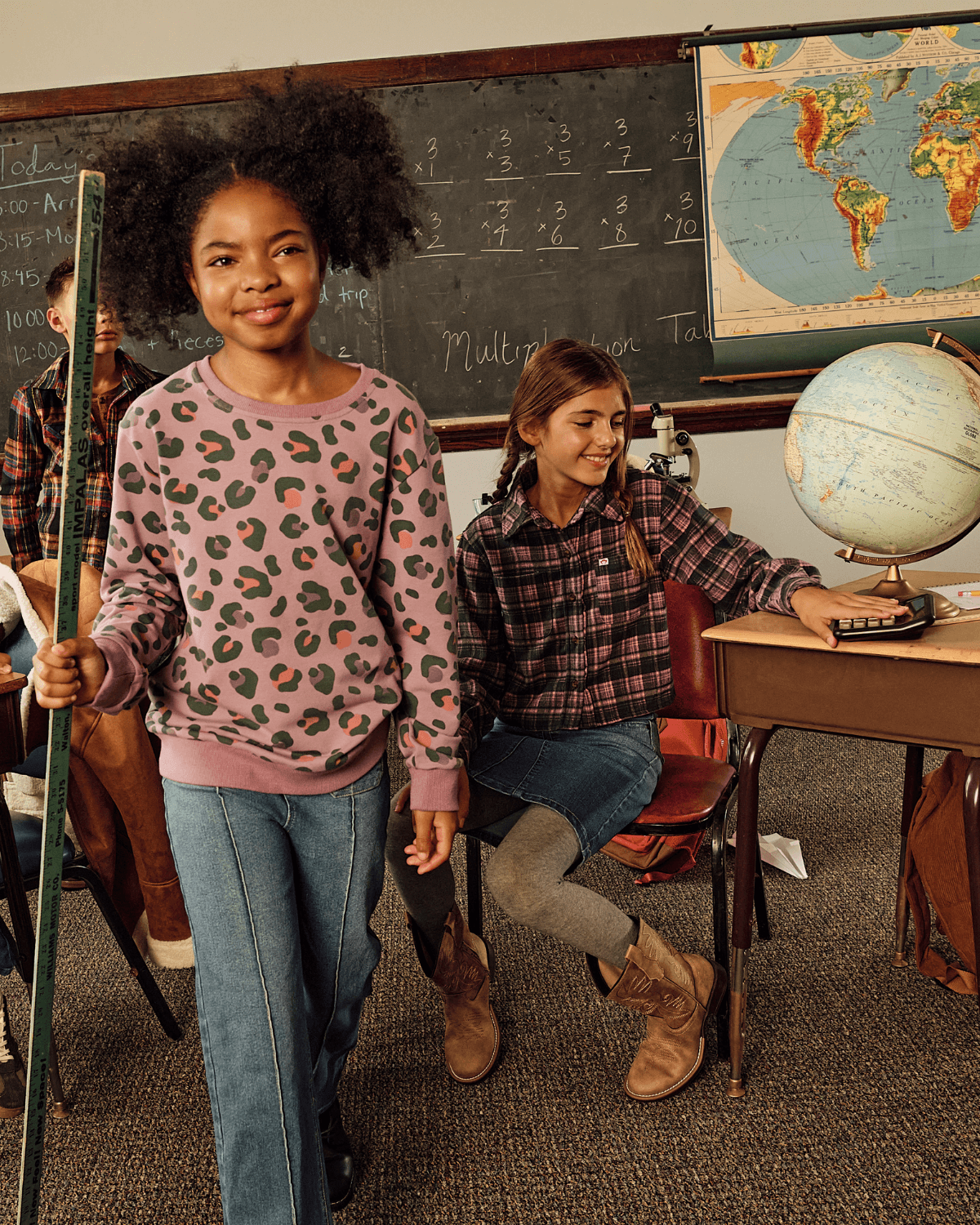 Medium Wash Wide Leg Jeans worn by a smiling girl in a classroom setting.