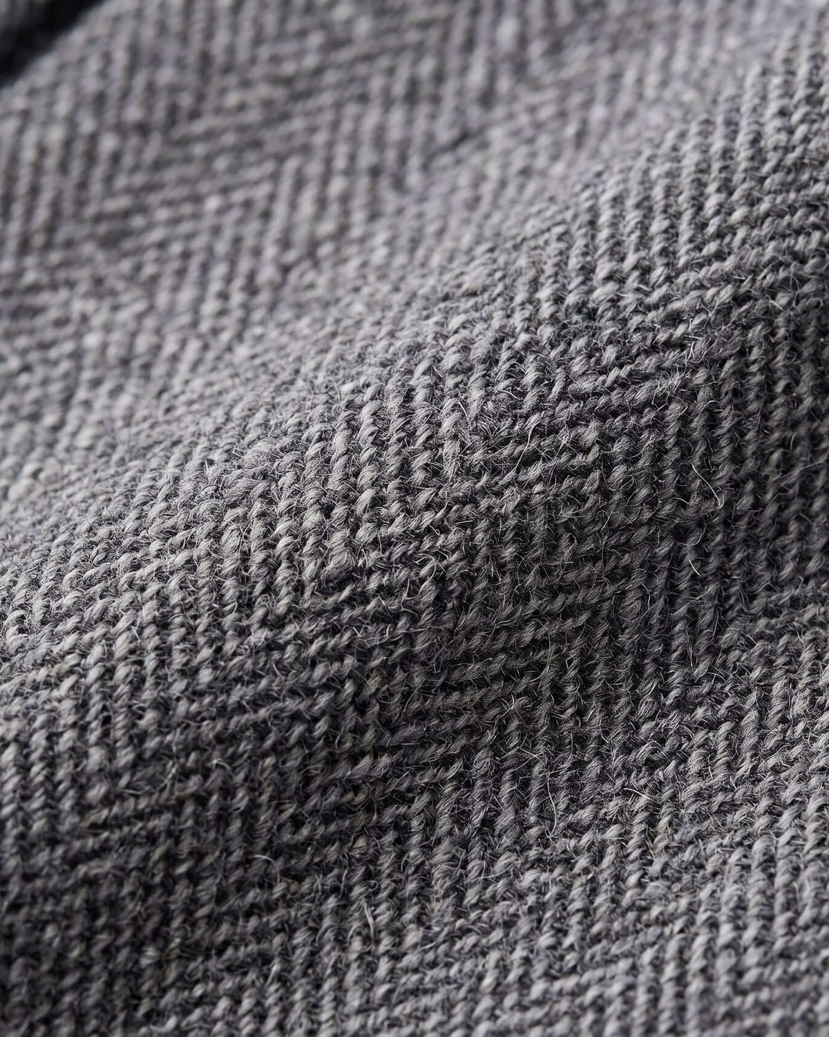 Close-up of luxurious fabric texture in gray herringbone pattern for Black Boucle Yoke Pleated Skirt.