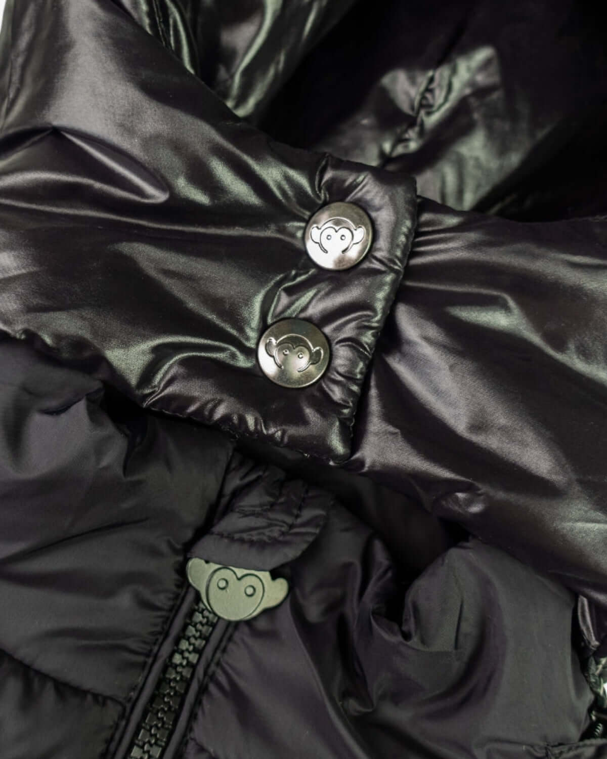 Close-up of Black Park Ave Long Puffer showing its soft insulated lining and stylish buttons.