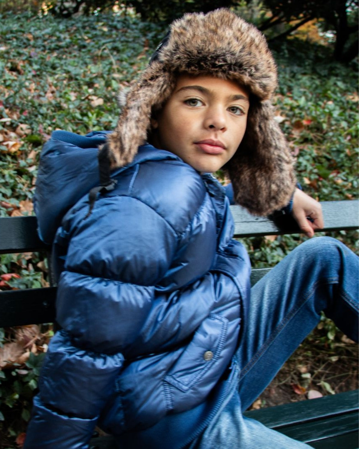 Chilly days just got stylish with this faux fur-lined boys' hat paired with a cozy blue puffer jacket. Perfect for back to school!