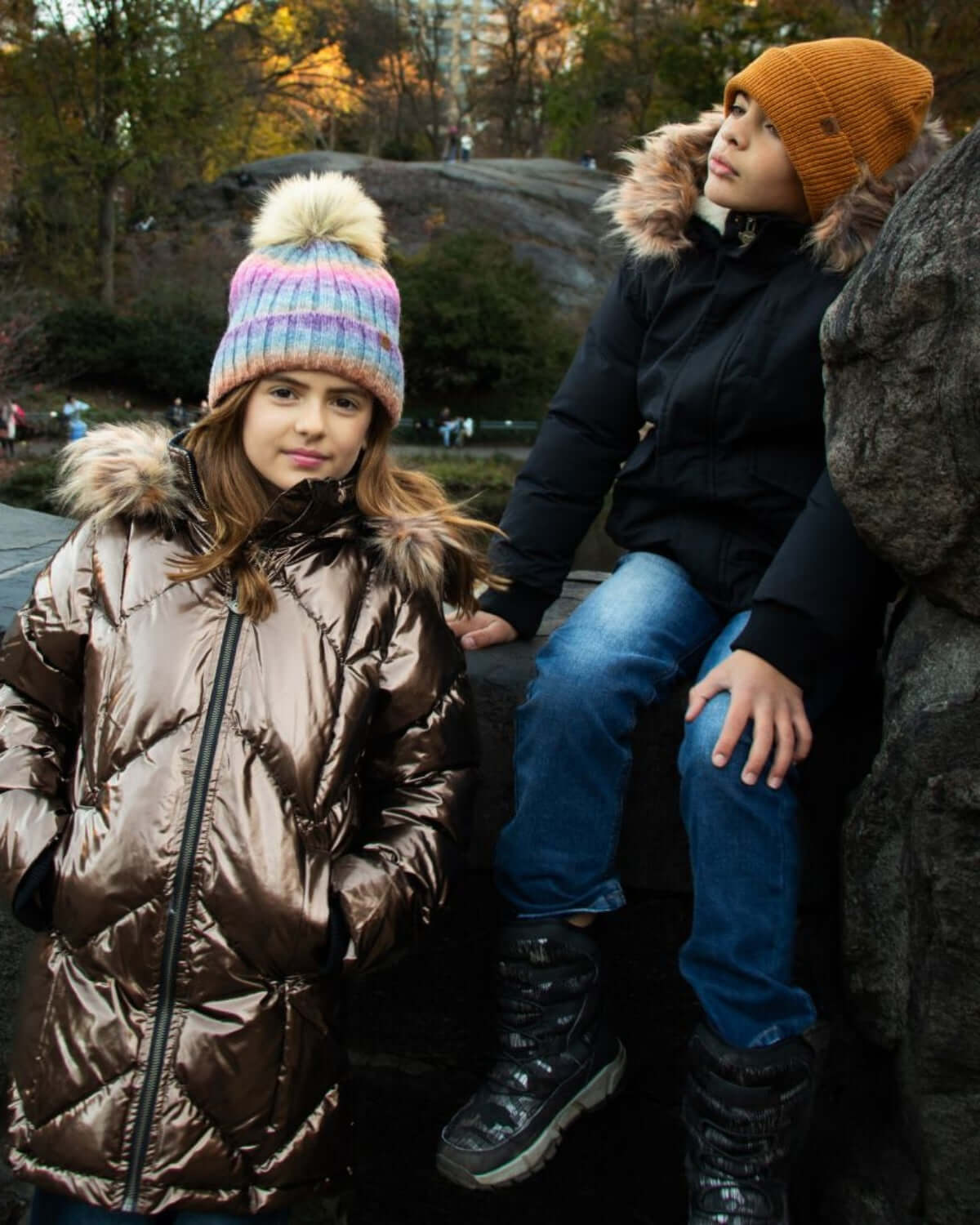 Two stylish kids in warm winter gear, showcasing Appaman's chic coats and hats—perfect for back to school fun!