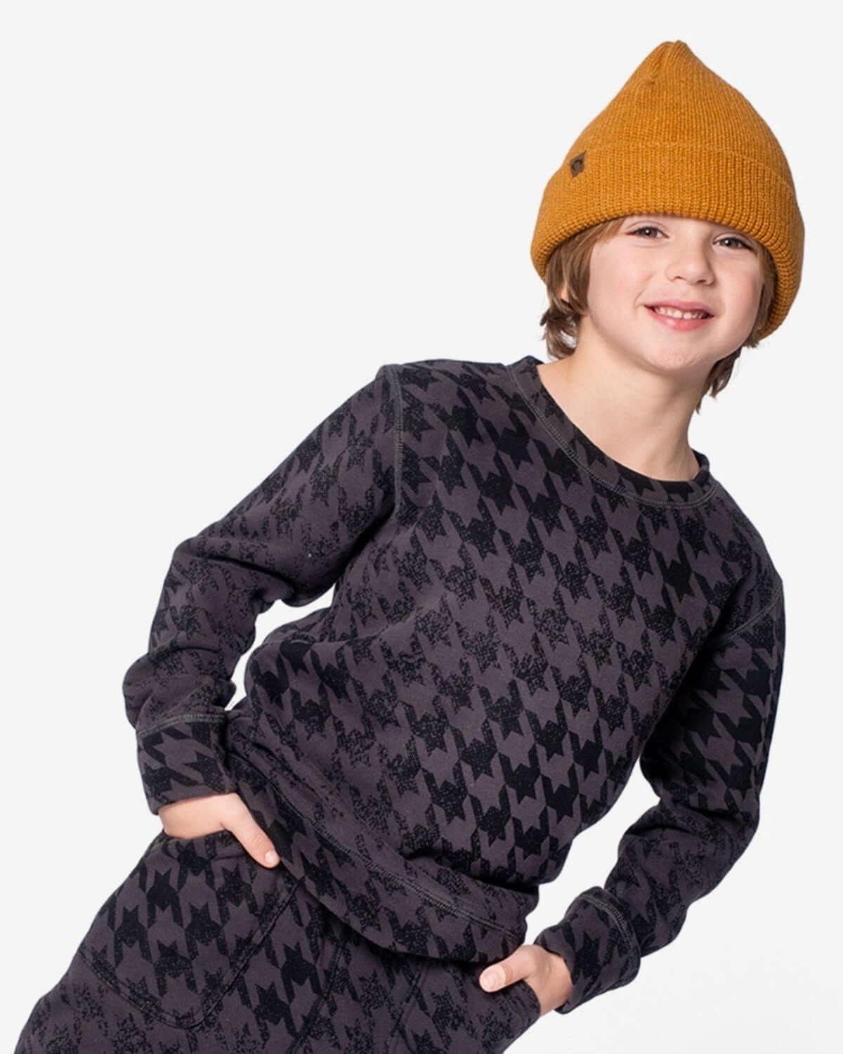Stylish kid rocking the Golden Spice Haze Hat with a trendy houndstooth sweater, perfect for cool school days!